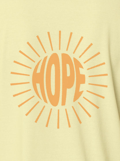 Close up of 'Hope' design on Women's Yellow Polo T-shirt, highlighting intricate details and vibrant print.