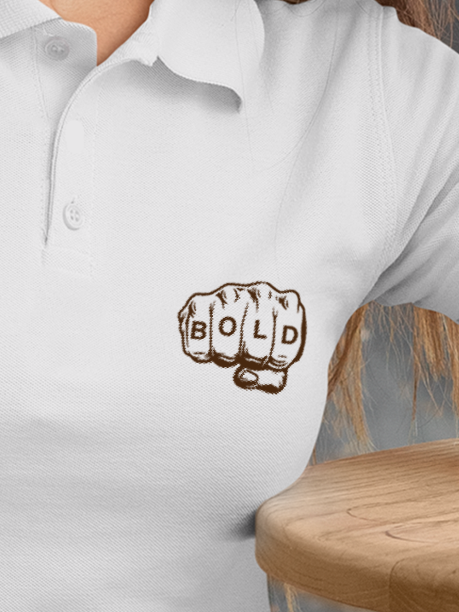 Close up of 'Bold' design on Women's White Polo T-shirt, highlighting intricate details and vibrant print.