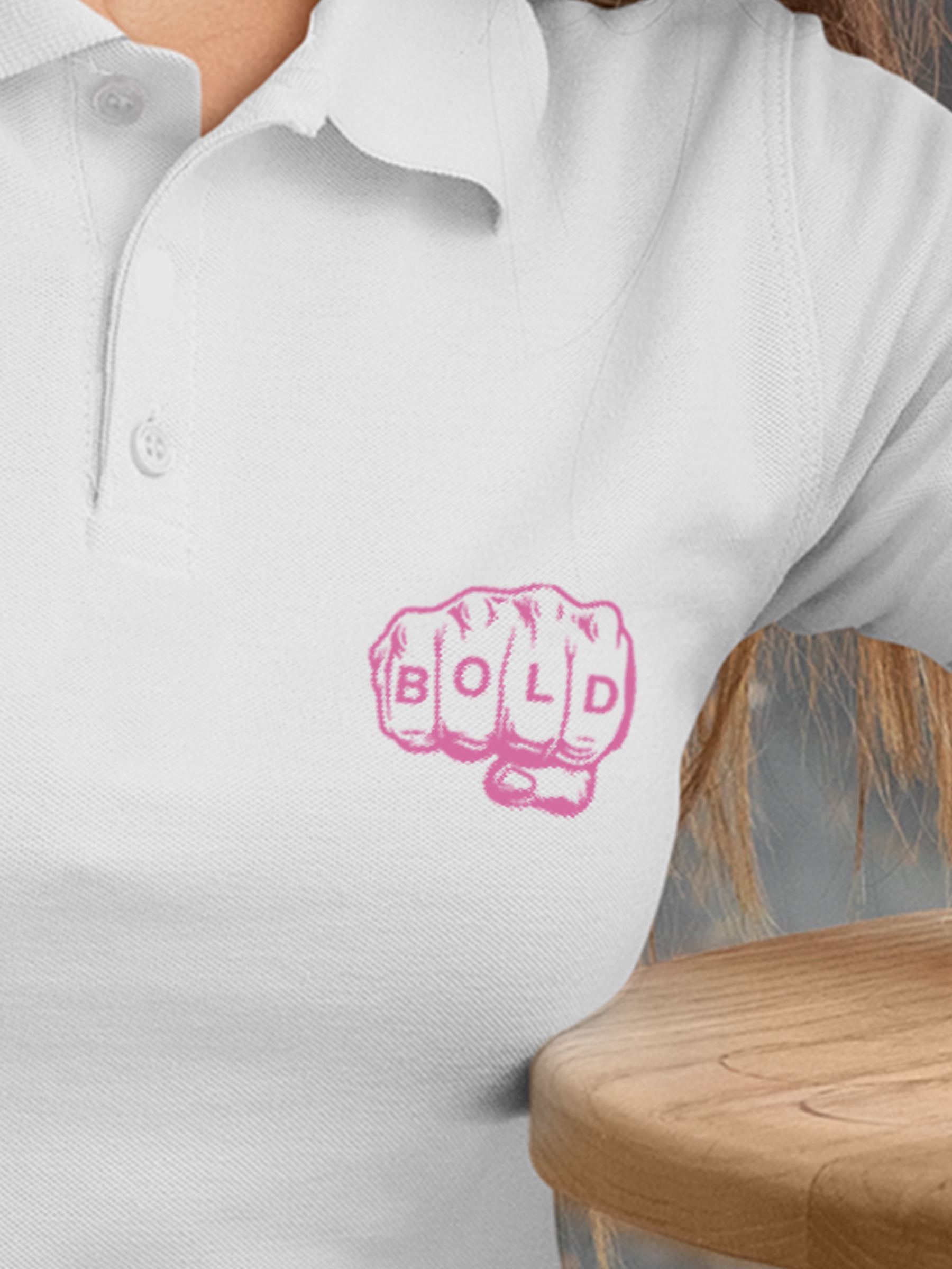 Close up of 'Bold' design on Women's White Polo T-shirt, highlighting intricate details and vibrant print.