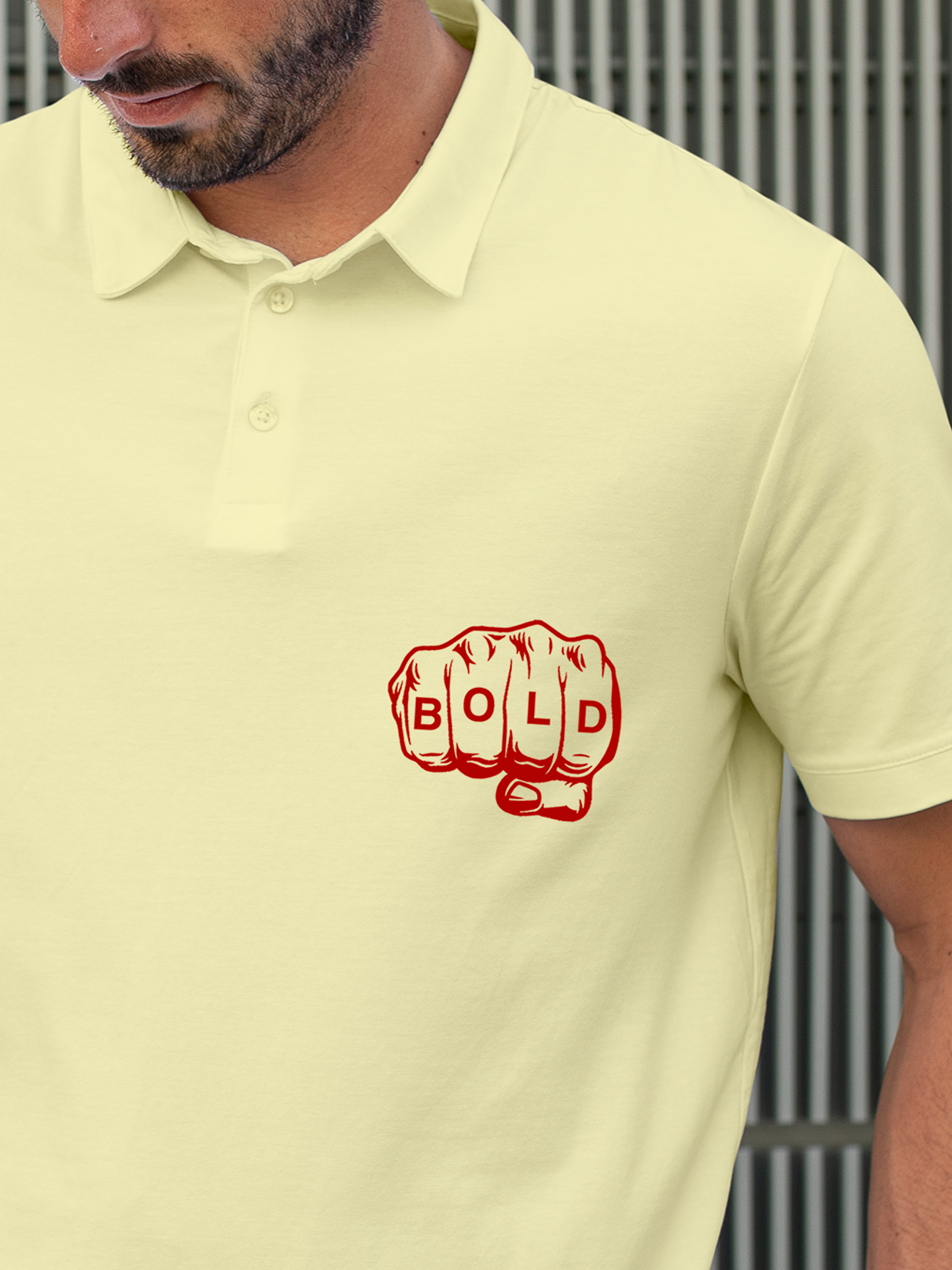 Close up of 'Bold' design on Men's Yellow Polo T-shirt, highlighting intricate details and vibrant print.