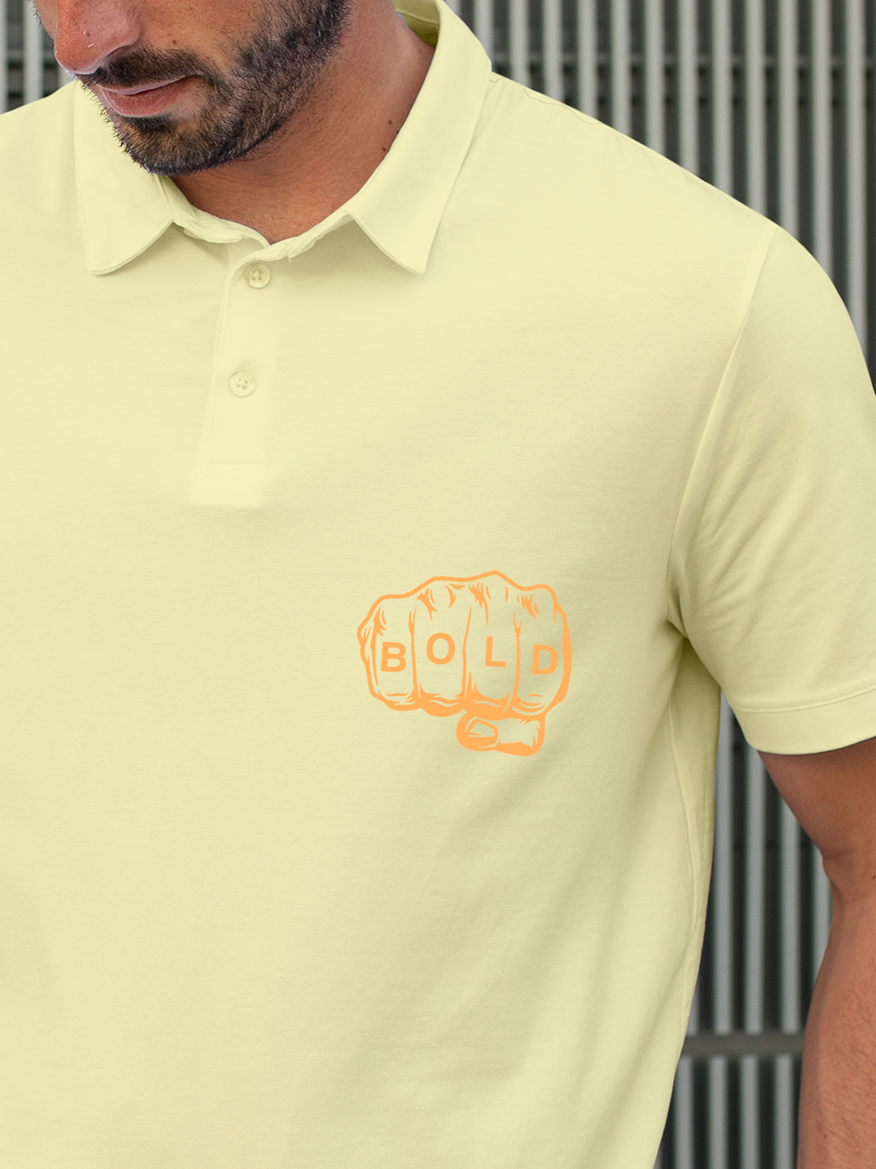 Close up of 'Bold' design on Men's Yellow Polo T-shirt, highlighting intricate details and vibrant print.
