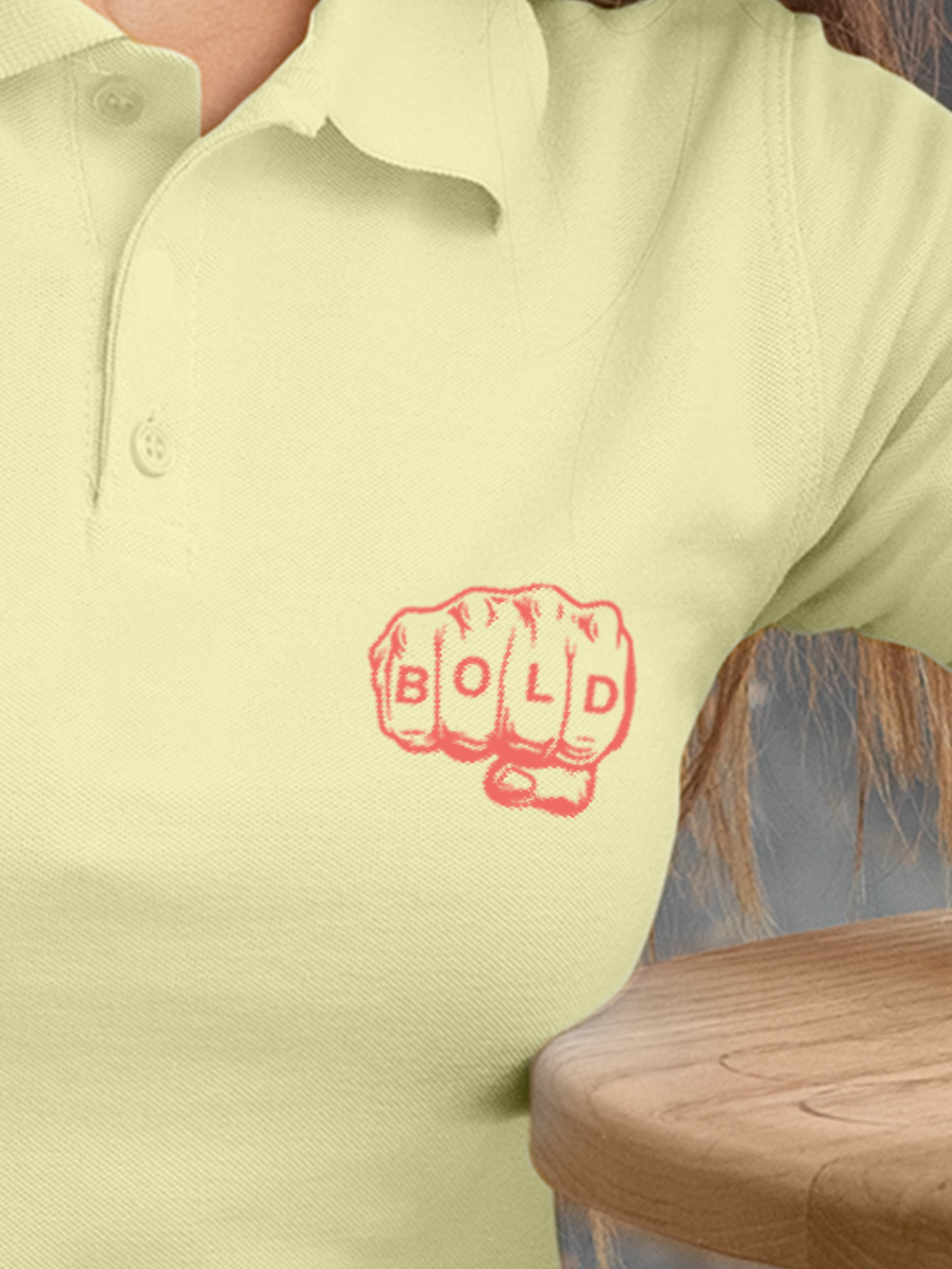 Close up of 'Bold' design on Women's Yellow Polo T-shirt, highlighting intricate details and vibrant print.