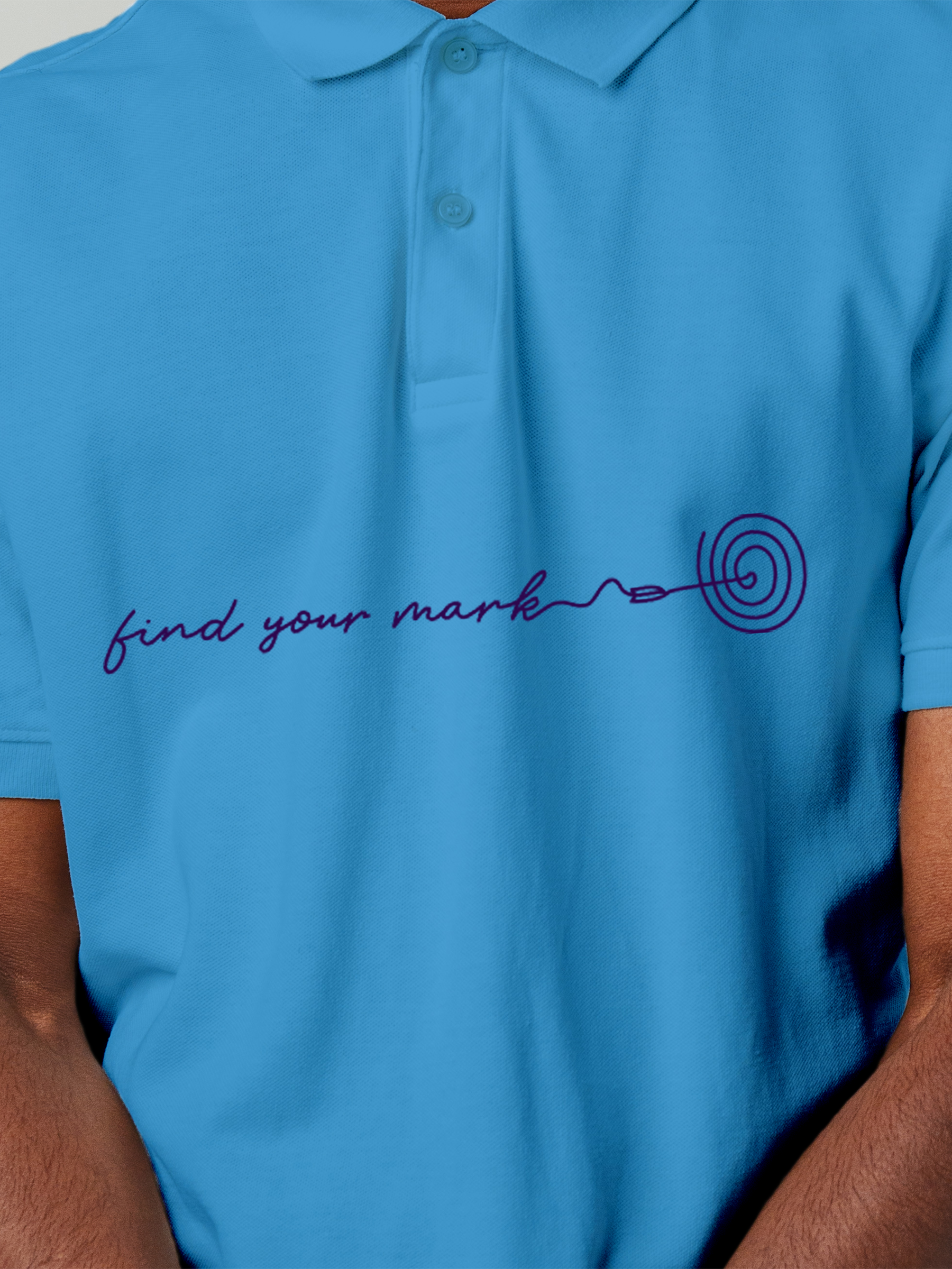 Close up of 'Find Your Mark' design on Men's Blue Polo T-shirt, highlighting intricate details and vibrant print.