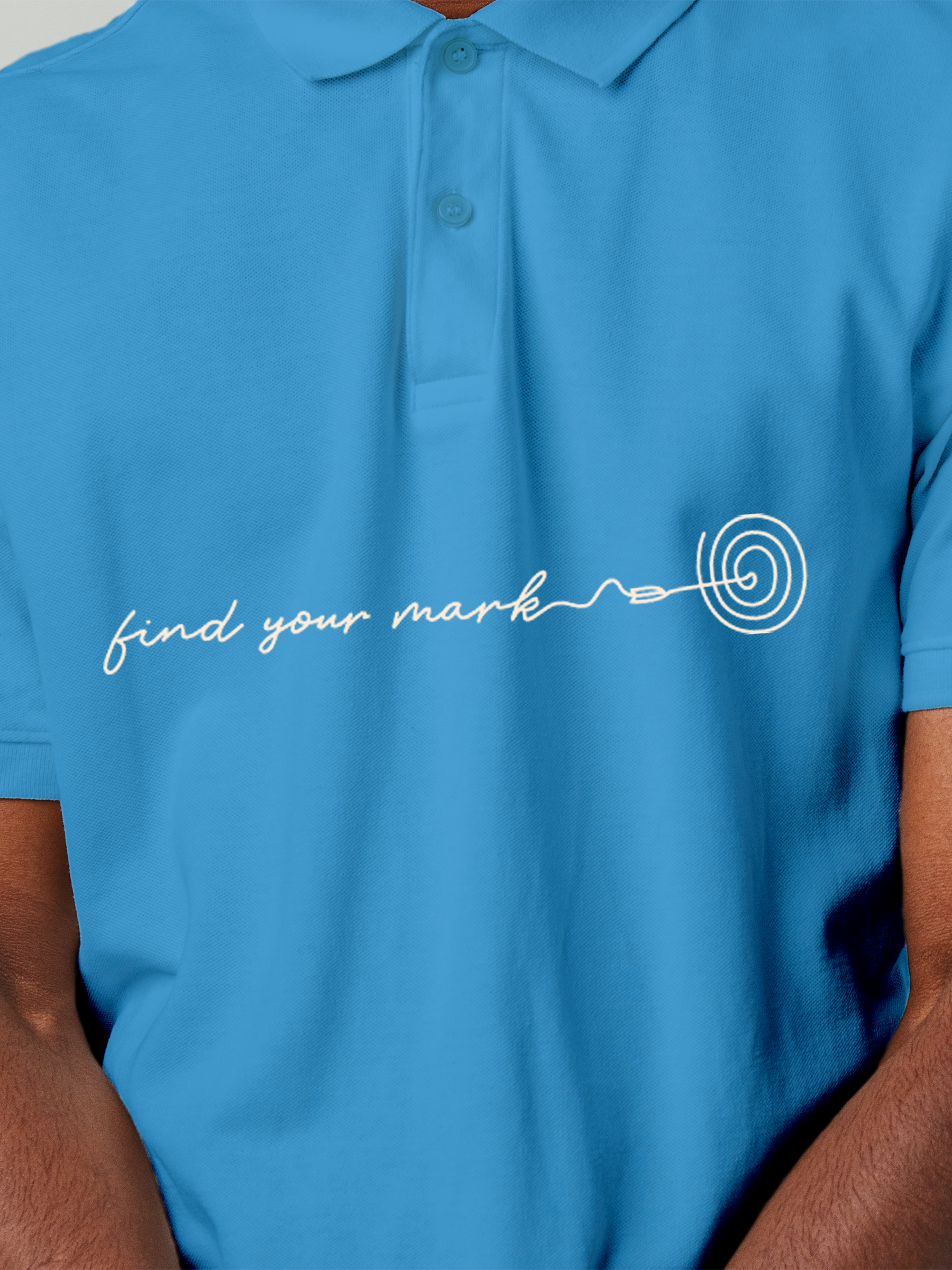 Close up of 'Find Your Mark' design on Men's Blue Polo T-shirt, highlighting intricate details and vibrant print.