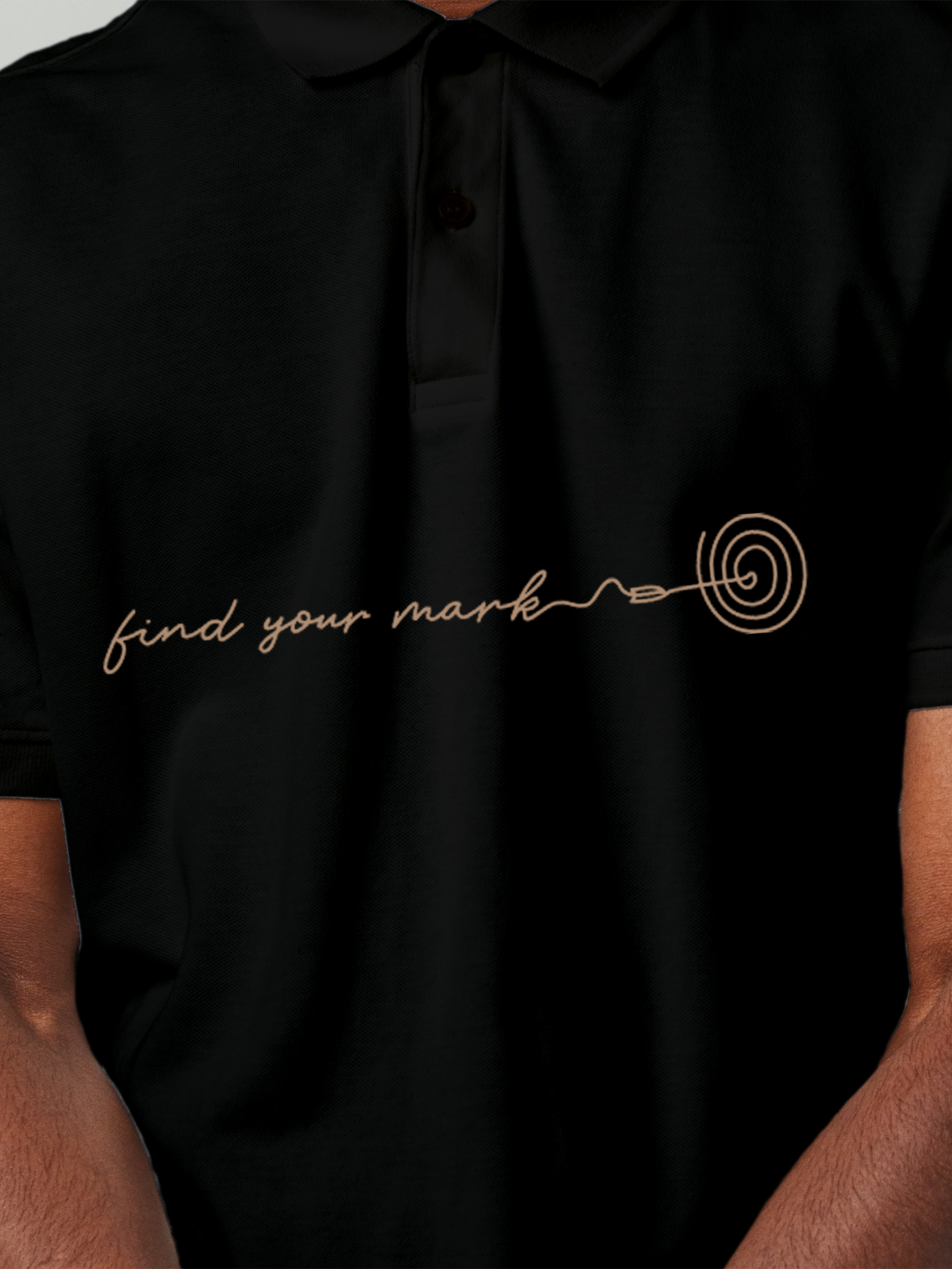 Close up of 'Find Your Mark' design on Men's Black Polo T-shirt, highlighting intricate details and vibrant print.