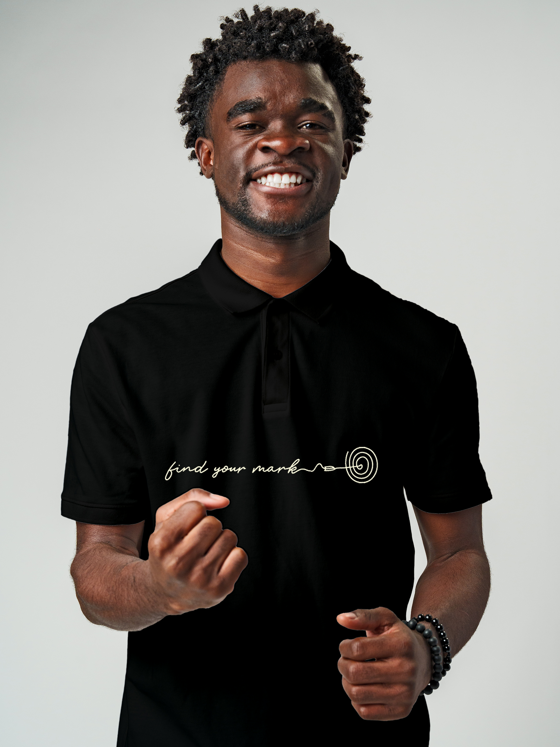 Model wearing Men's Black Polo T-shirt with 'Find Your Mark' design, offering effortless style and premium comfort