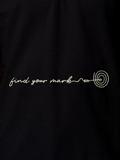 Close up of 'Find Your Mark' design on Men's Black Polo T-shirt, highlighting intricate details and vibrant print.