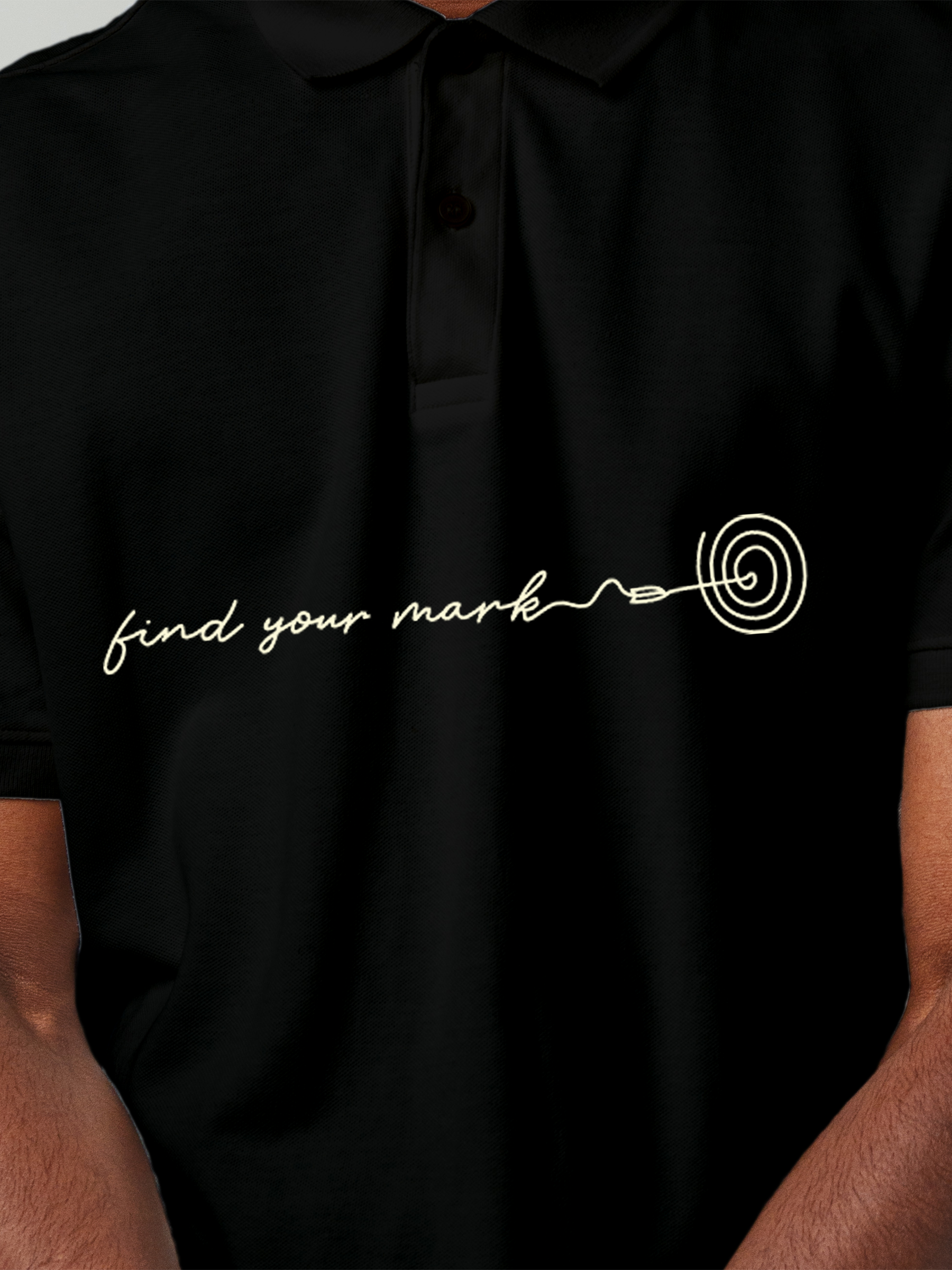 Close up of 'Find Your Mark' design on Men's Black Polo T-shirt, highlighting intricate details and vibrant print.