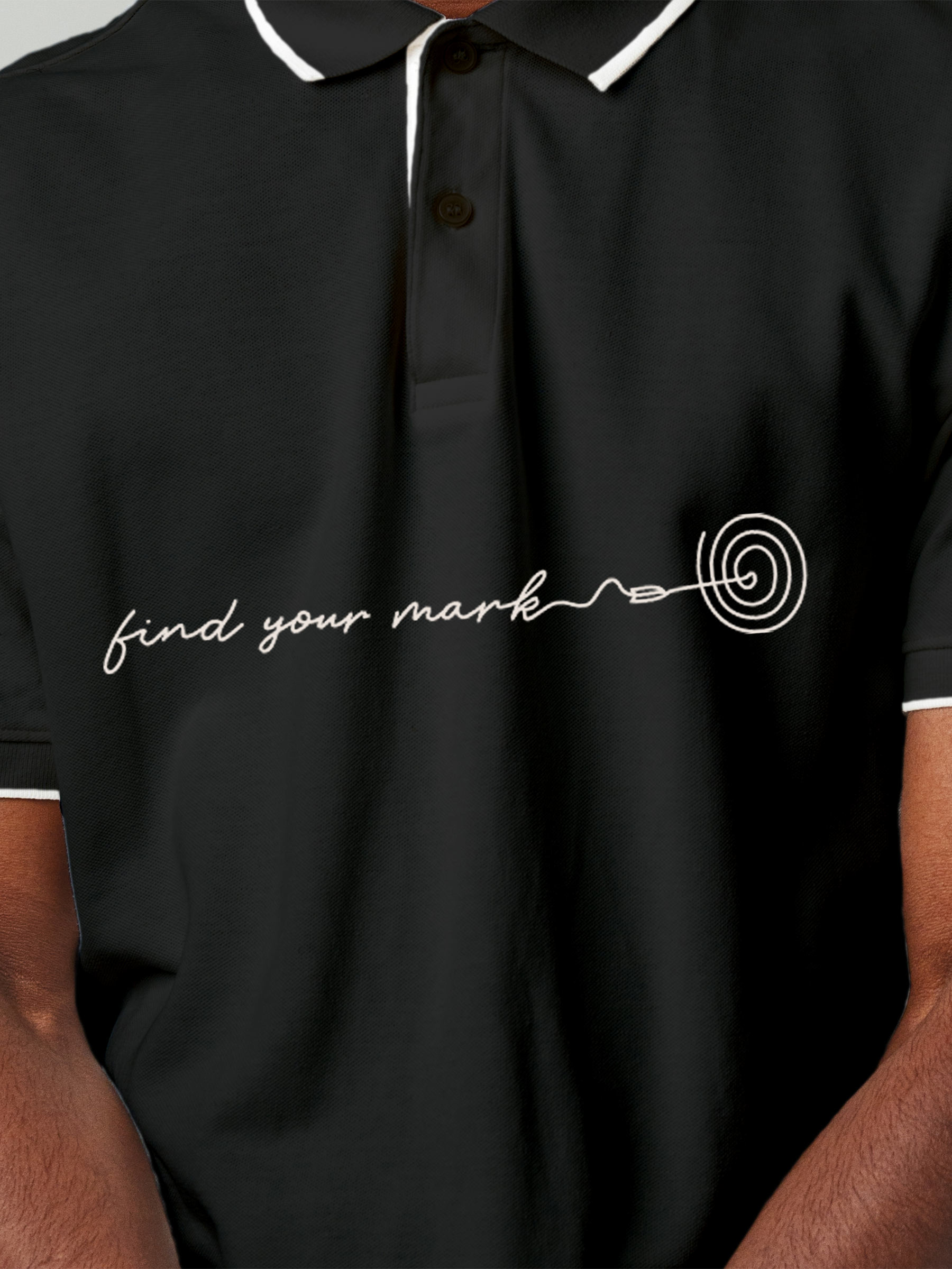 Close up of 'Find Your Mark' design on Men's Charcoal Grey Polo T-shirt, highlighting intricate details and vibrant print.