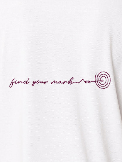 Close up of 'Find Your Mark' design on Women's White Polo T-shirt, highlighting intricate details and vibrant print.