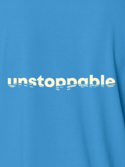 Close up of 'Unstoppable' design on Men's Blue Polo T-shirt, highlighting intricate details and vibrant print.