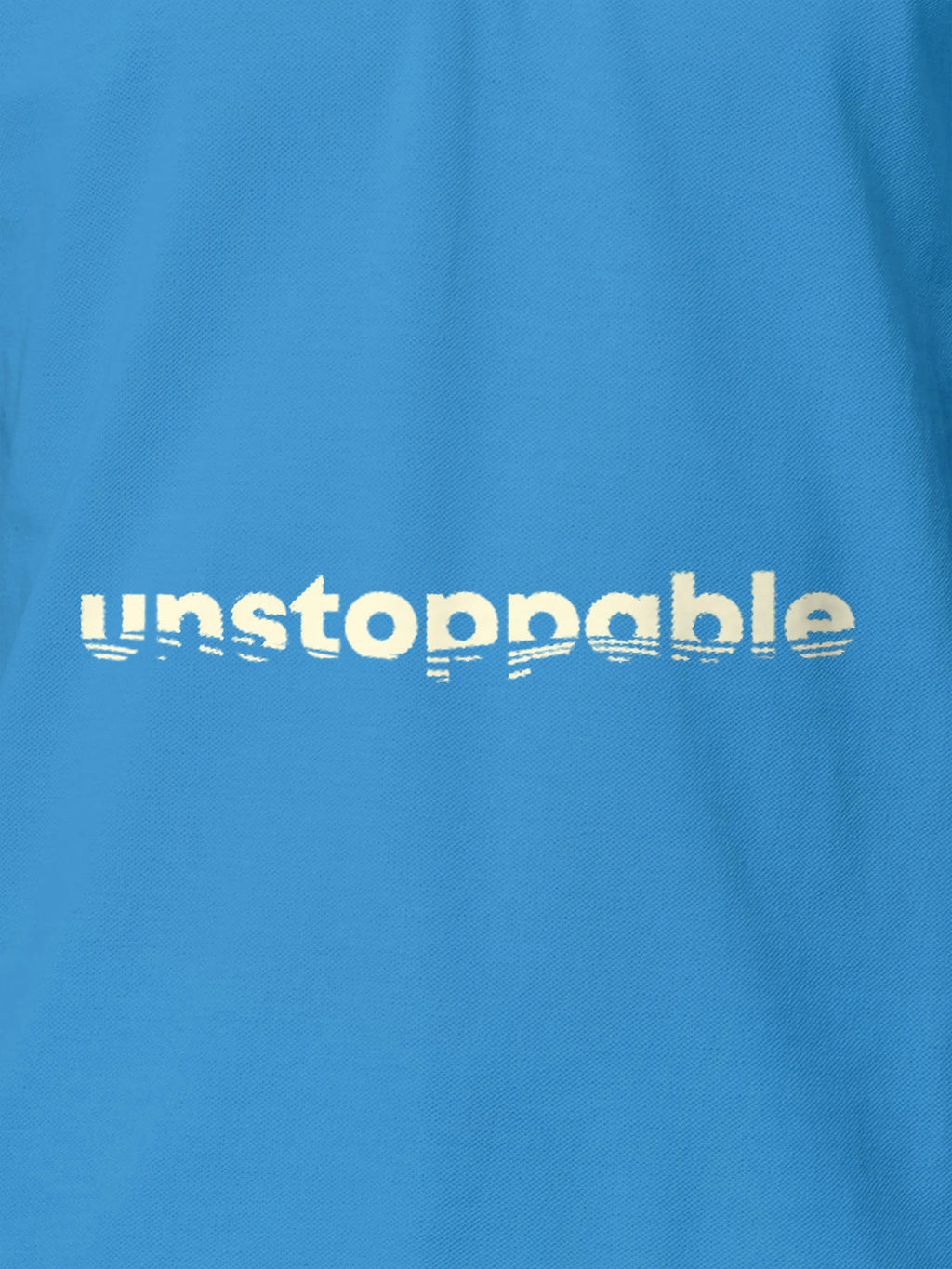 Close up of 'Unstoppable' design on Women's Blue Polo T-shirt, highlighting intricate details and vibrant print.