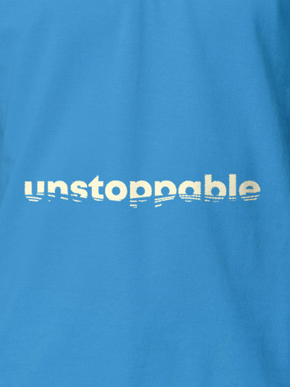 Close up of 'Unstoppable' design on Women's Blue Polo T-shirt, highlighting intricate details and vibrant print.