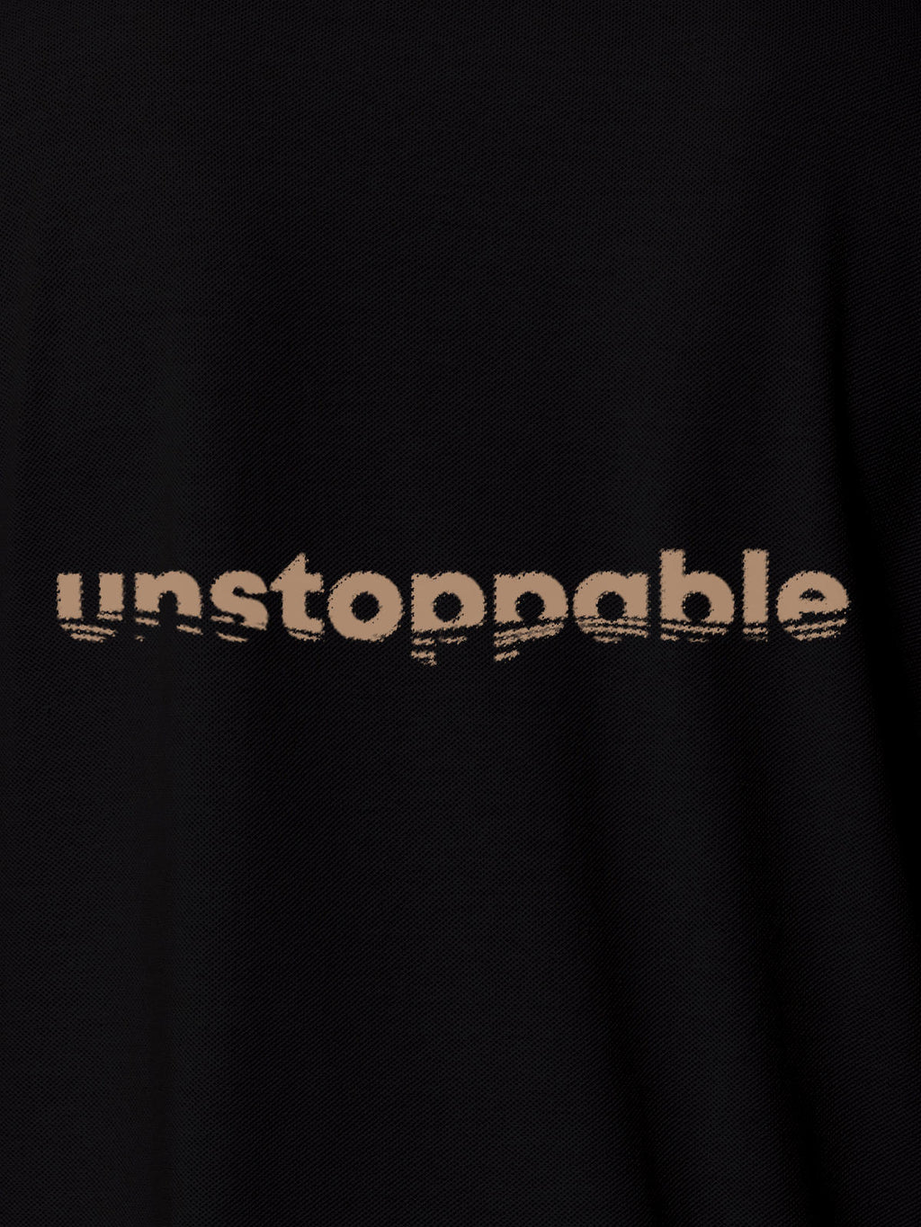 Close up of 'Unstoppable' design on Men's Black Polo T-shirt, highlighting intricate details and vibrant print.