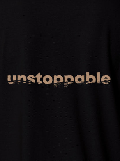 Close up of 'Unstoppable' design on Men's Black Polo T-shirt, highlighting intricate details and vibrant print.