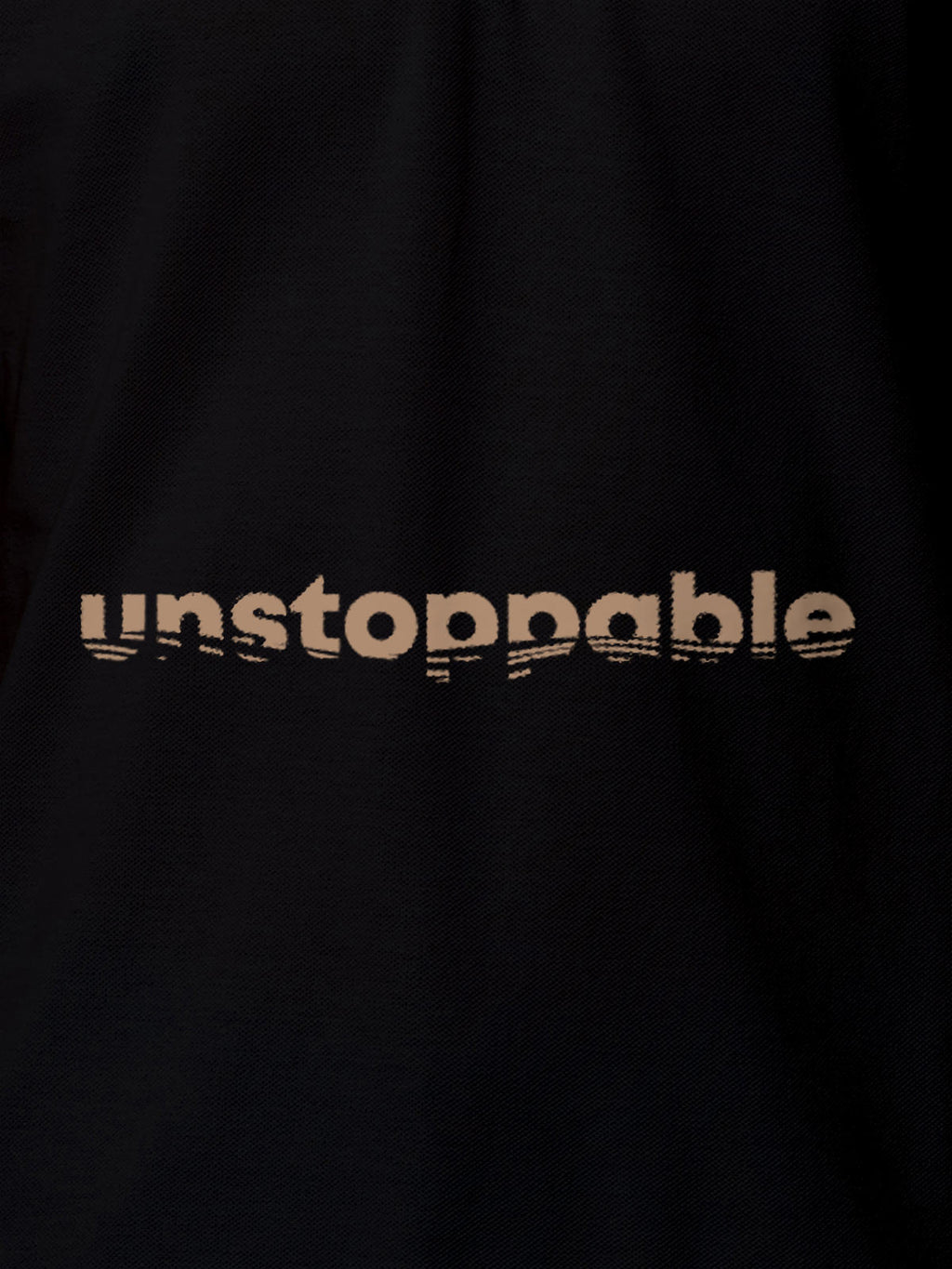 Close up of 'Unstoppable' design on Women's Black Polo T-shirt, highlighting intricate details and vibrant print.
