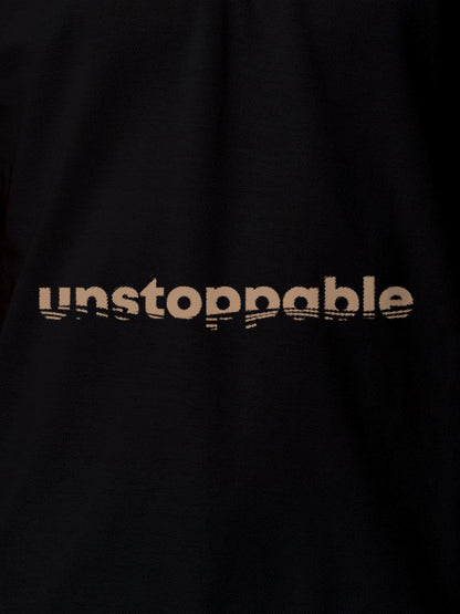 Close up of 'Unstoppable' design on Women's Black Polo T-shirt, highlighting intricate details and vibrant print.