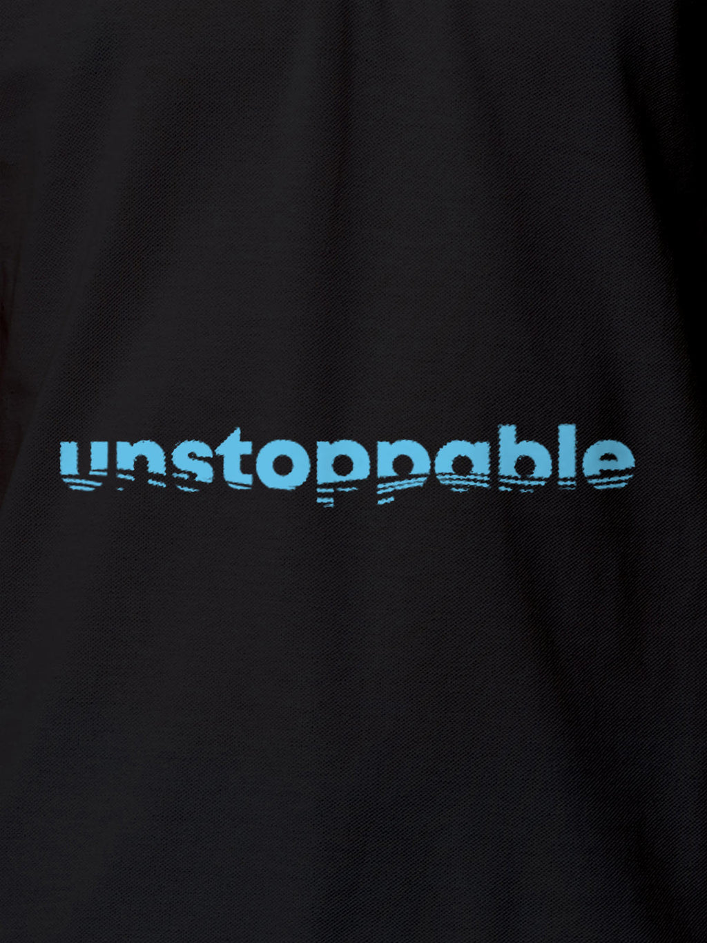 Close up of 'Unstoppable' design on Women's Dark Grey Polo T-shirt, highlighting intricate details and vibrant print.