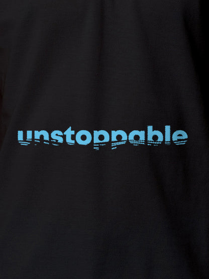 Close up of 'Unstoppable' design on Women's Dark Grey Polo T-shirt, highlighting intricate details and vibrant print.