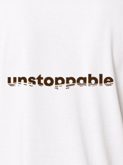 Close up of 'Unstoppable' design on Men's White Polo T-shirt, highlighting intricate details and vibrant print.
