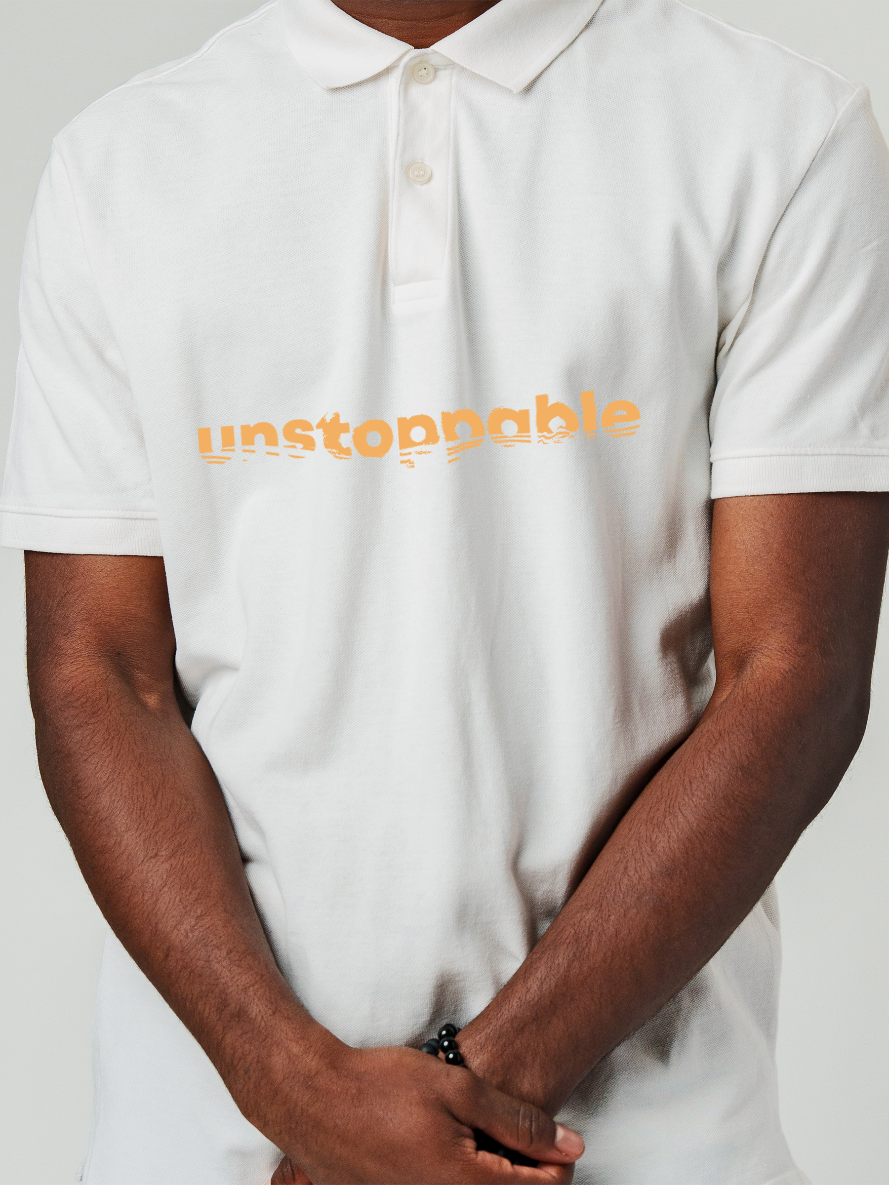 Close up of 'Unstoppable' design on Men's White Polo T-shirt, highlighting intricate details and vibrant print.