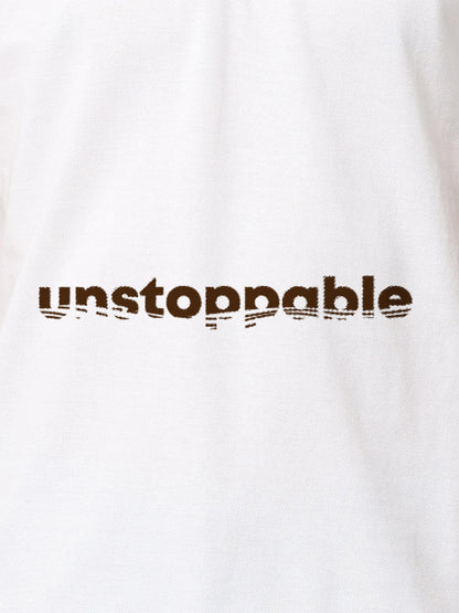 Close up of 'Unstoppable' design on Women's White Polo T-shirt, highlighting intricate details and vibrant print.