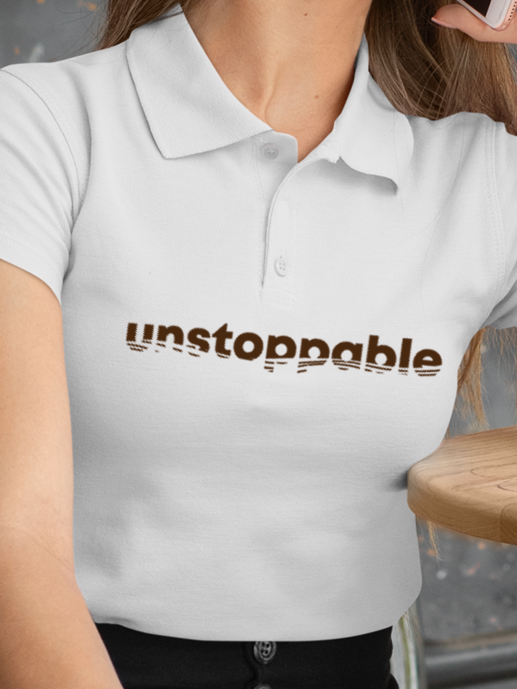 Close up of 'Unstoppable' design on Women's White Polo T-shirt, highlighting intricate details and vibrant print.