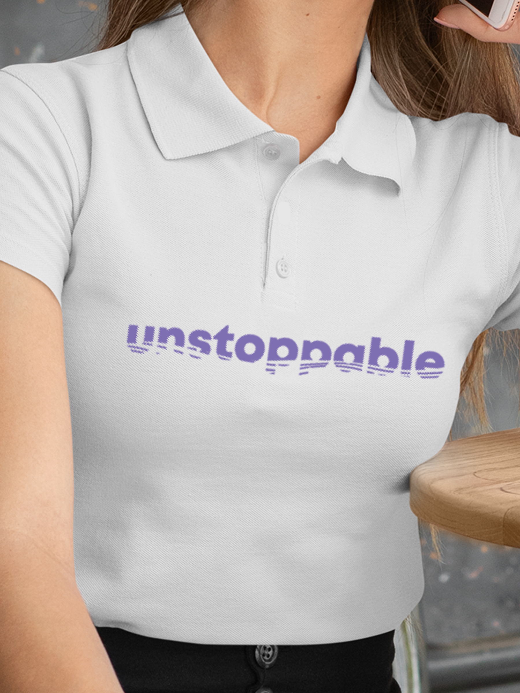 Close up of 'Unstoppable' design on Women's White Polo T-shirt, highlighting intricate details and vibrant print.