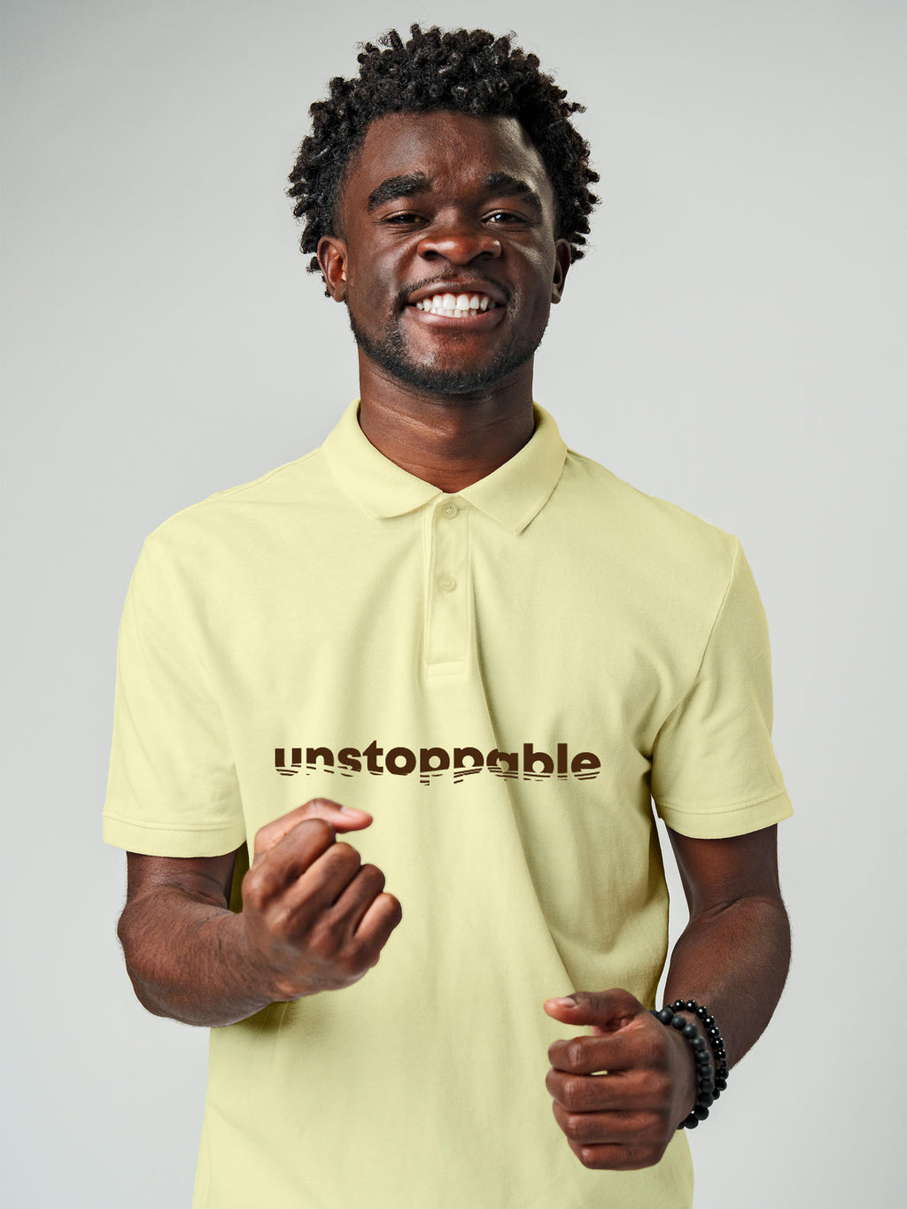 Model wearing Men's Yellow Polo T-shirt with 'Unstoppable' design, offering effortless style and premium comfort