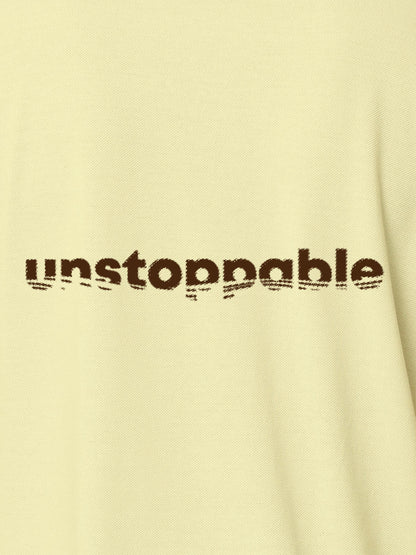 Close up of 'Unstoppable' design on Men's Yellow Polo T-shirt, highlighting intricate details and vibrant print.