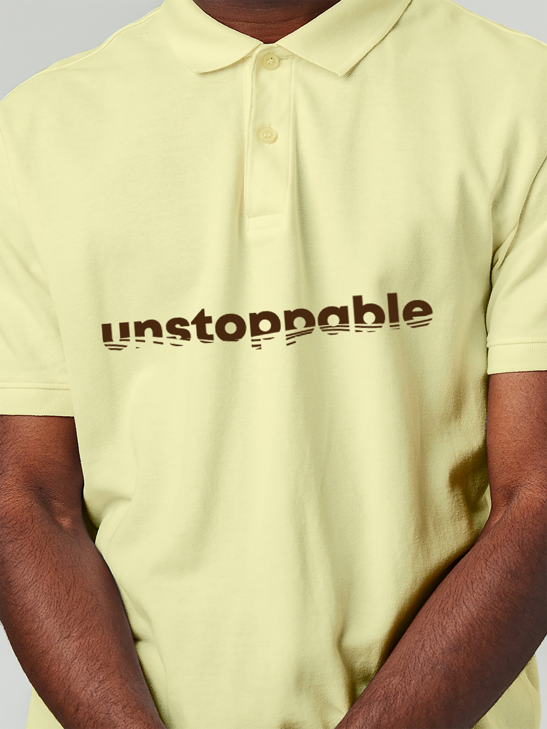 Close up of 'Unstoppable' design on Men's Yellow Polo T-shirt, highlighting intricate details and vibrant print.