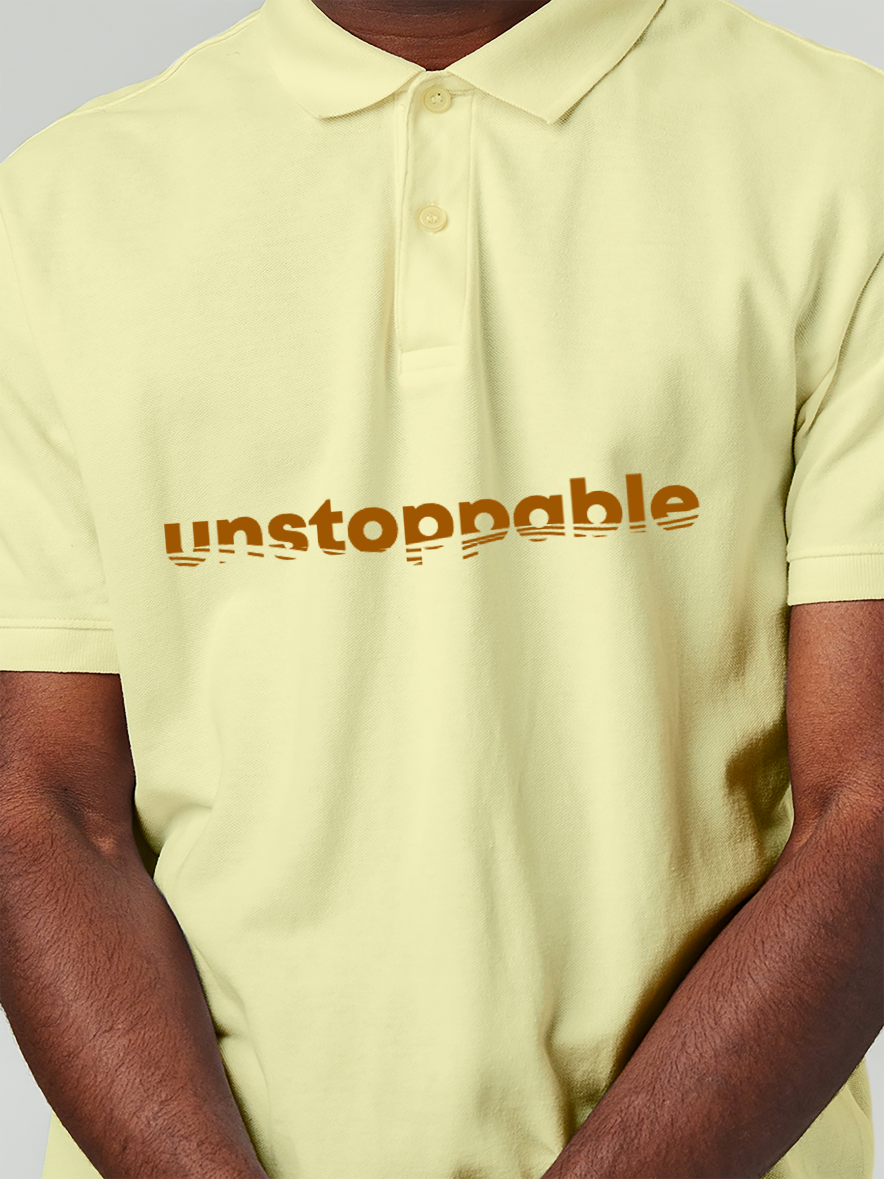 Close up of 'Unstoppable' design on Men's Yellow Polo T-shirt, highlighting intricate details and vibrant print.