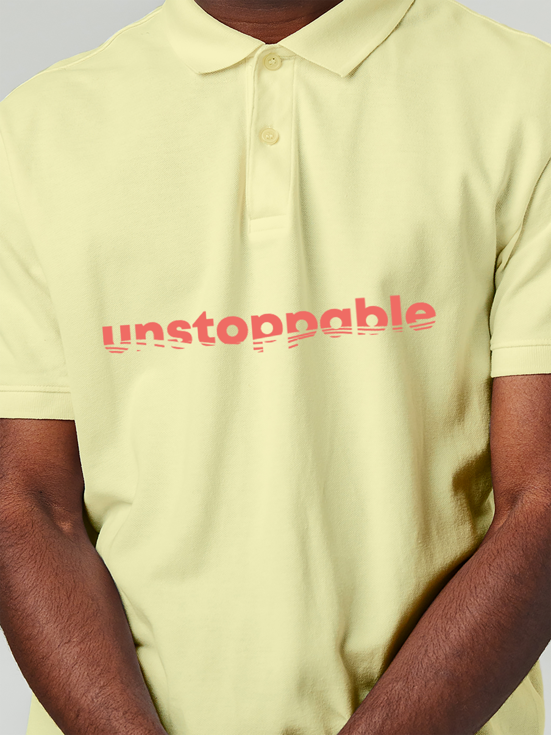 Close up of 'Unstoppable' design on Men's Yellow Polo T-shirt, highlighting intricate details and vibrant print.