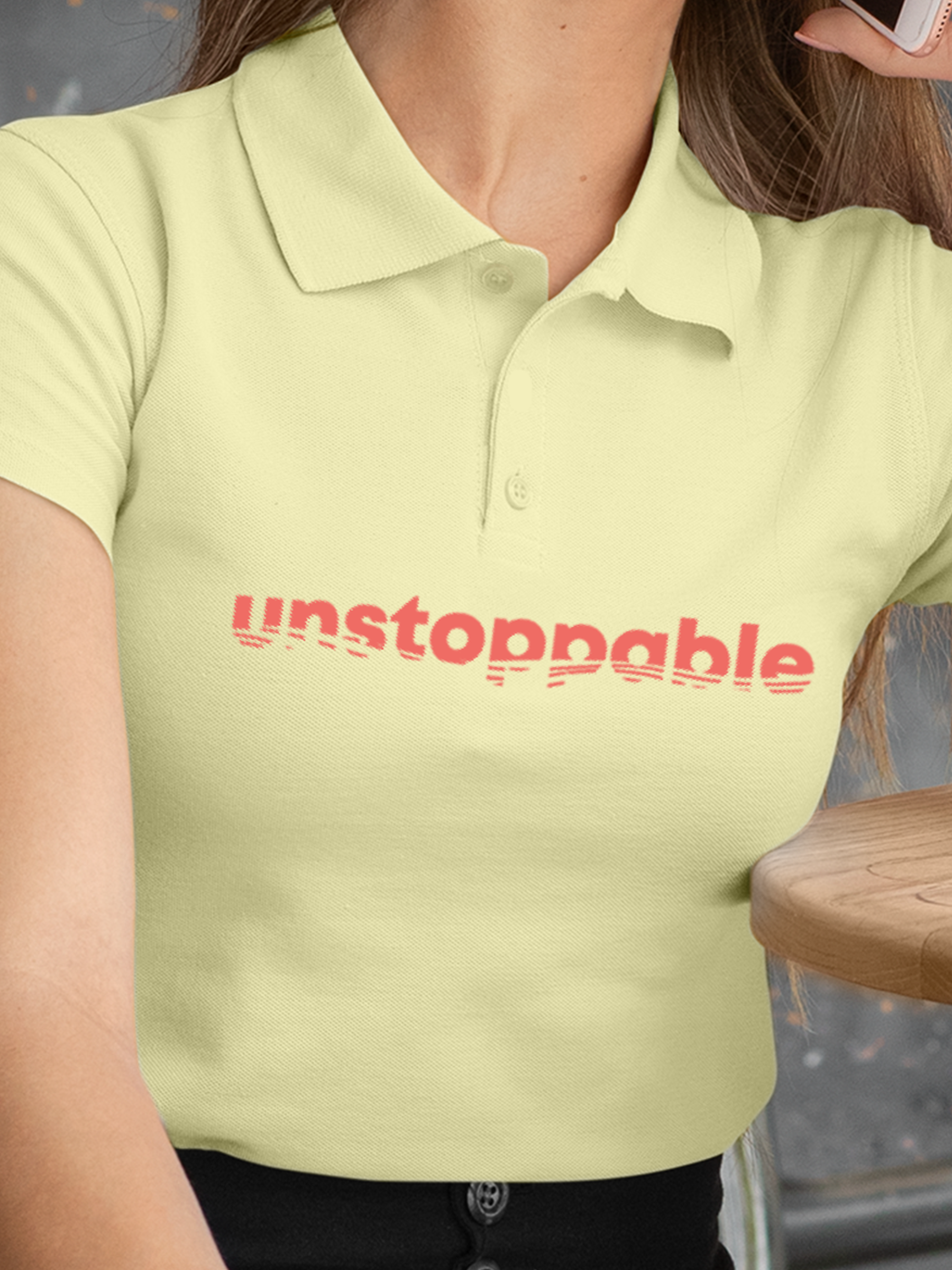 Close up of 'Unstoppable' design on Women's Yellow Polo T-shirt, highlighting intricate details and vibrant print.