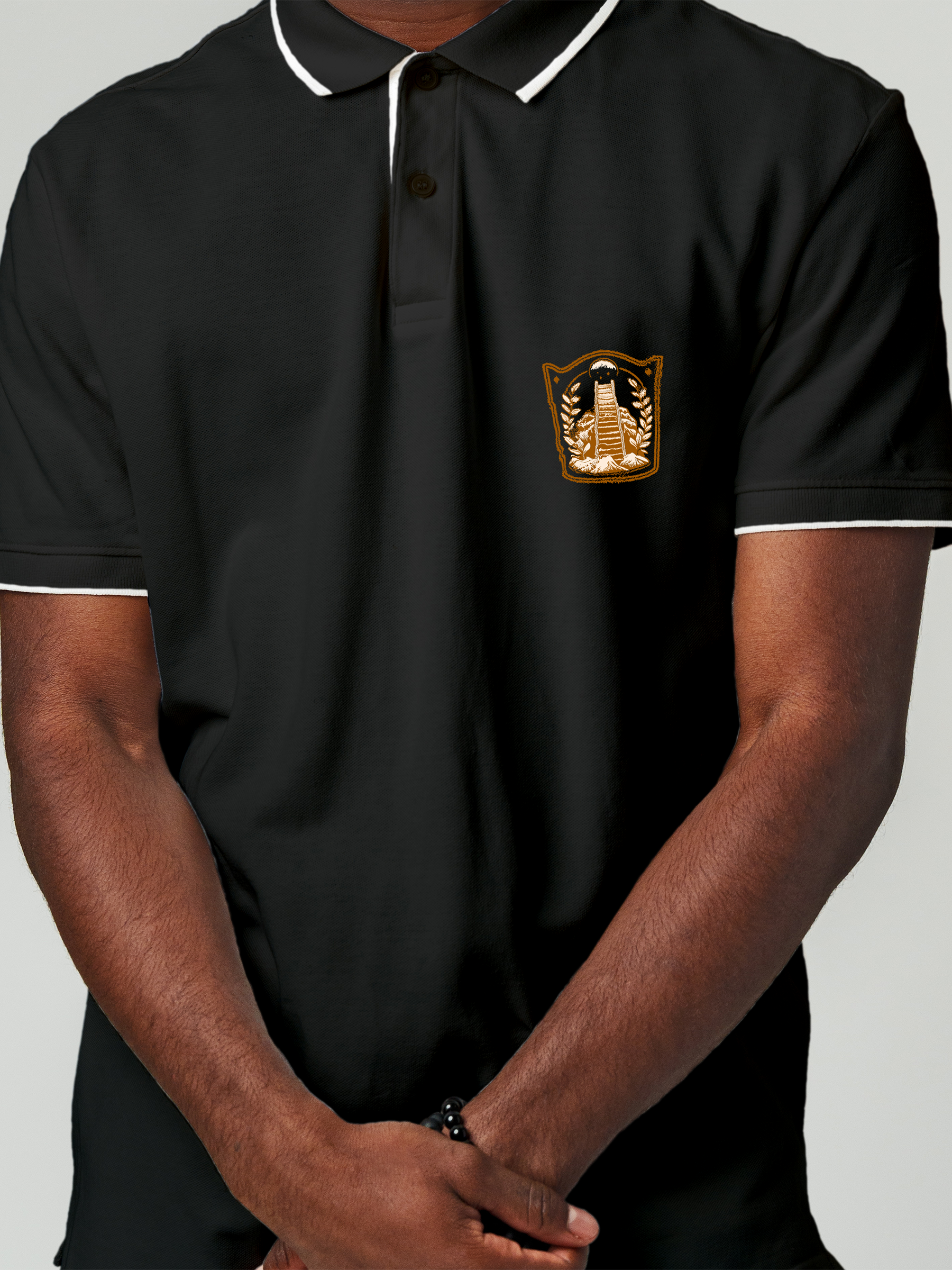 Close up of 'Ambition' design on Men's Charcoal Grey Polo T-shirt, highlighting intricate details and vibrant print.