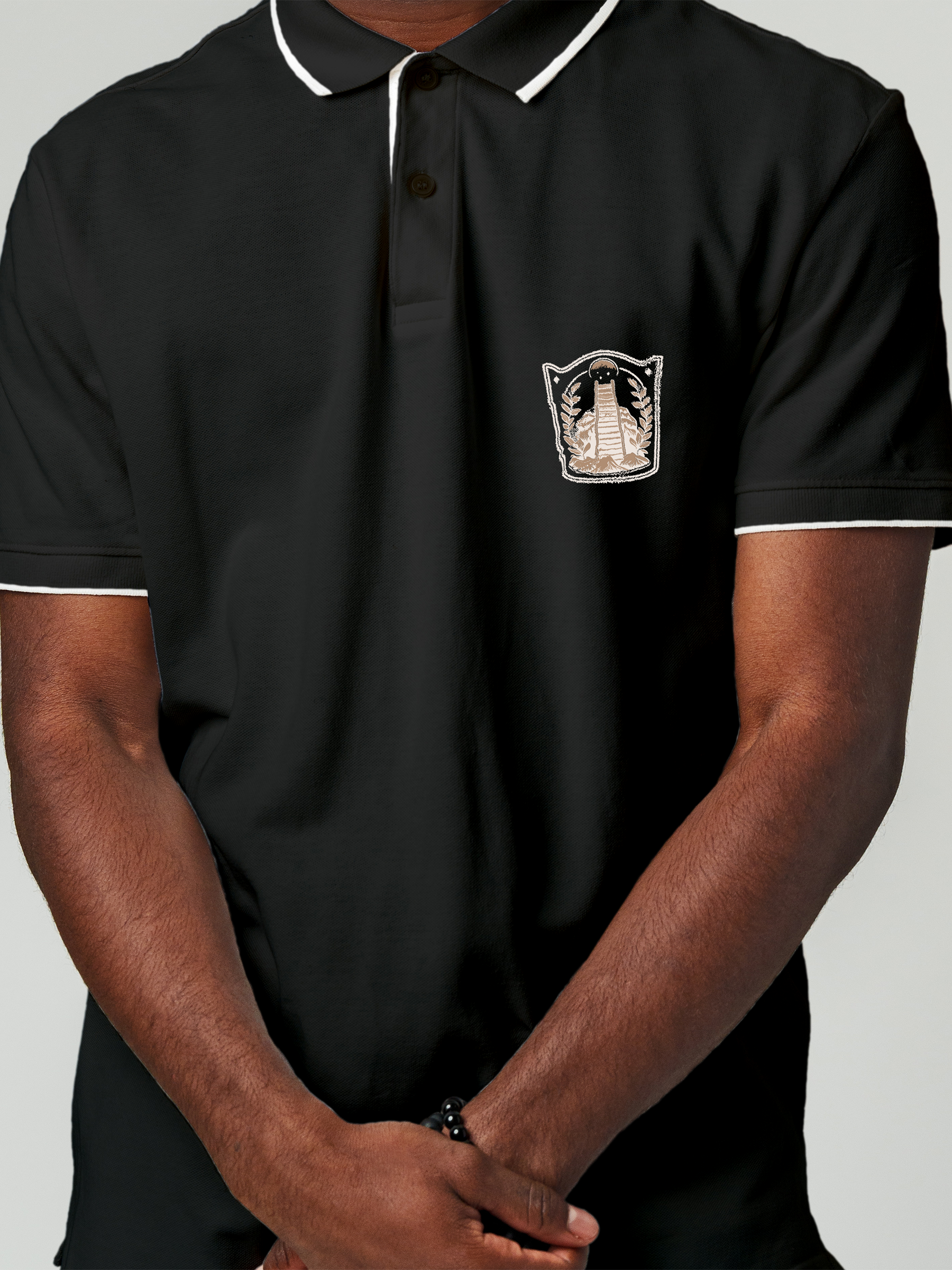 Close up of 'Ambition' design on Men's Charcoal Grey Polo T-shirt, highlighting intricate details and vibrant print.