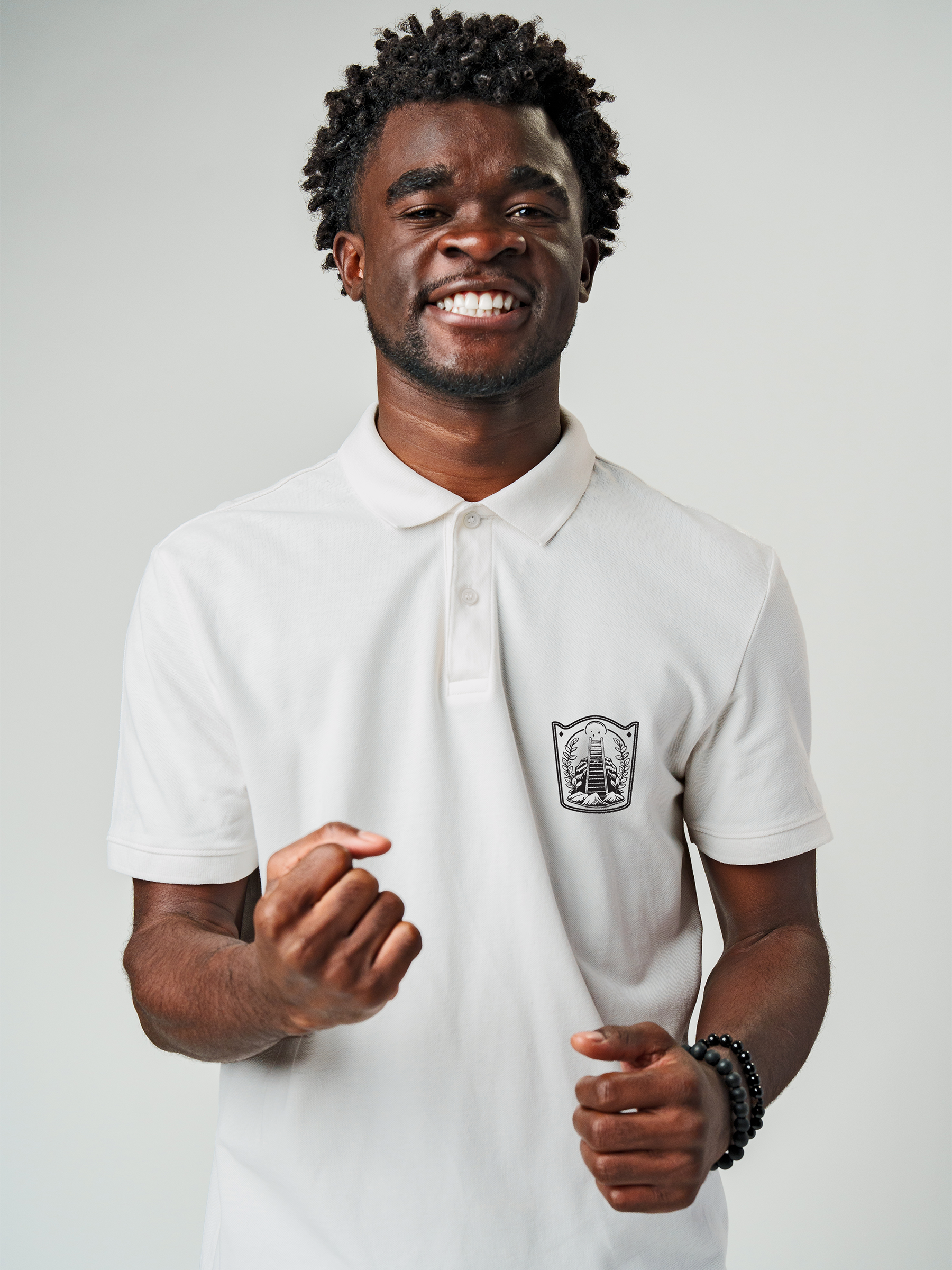 Model wearing Men's White Polo T-shirt with 'Ambition' design, offering effortless style and premium comfort