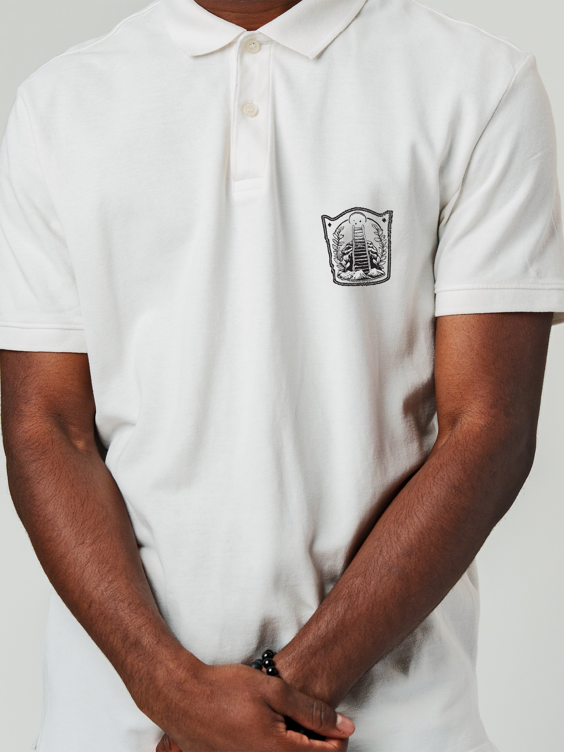 Close up of 'Ambition' design on Men's White Polo T-shirt, highlighting intricate details and vibrant print.