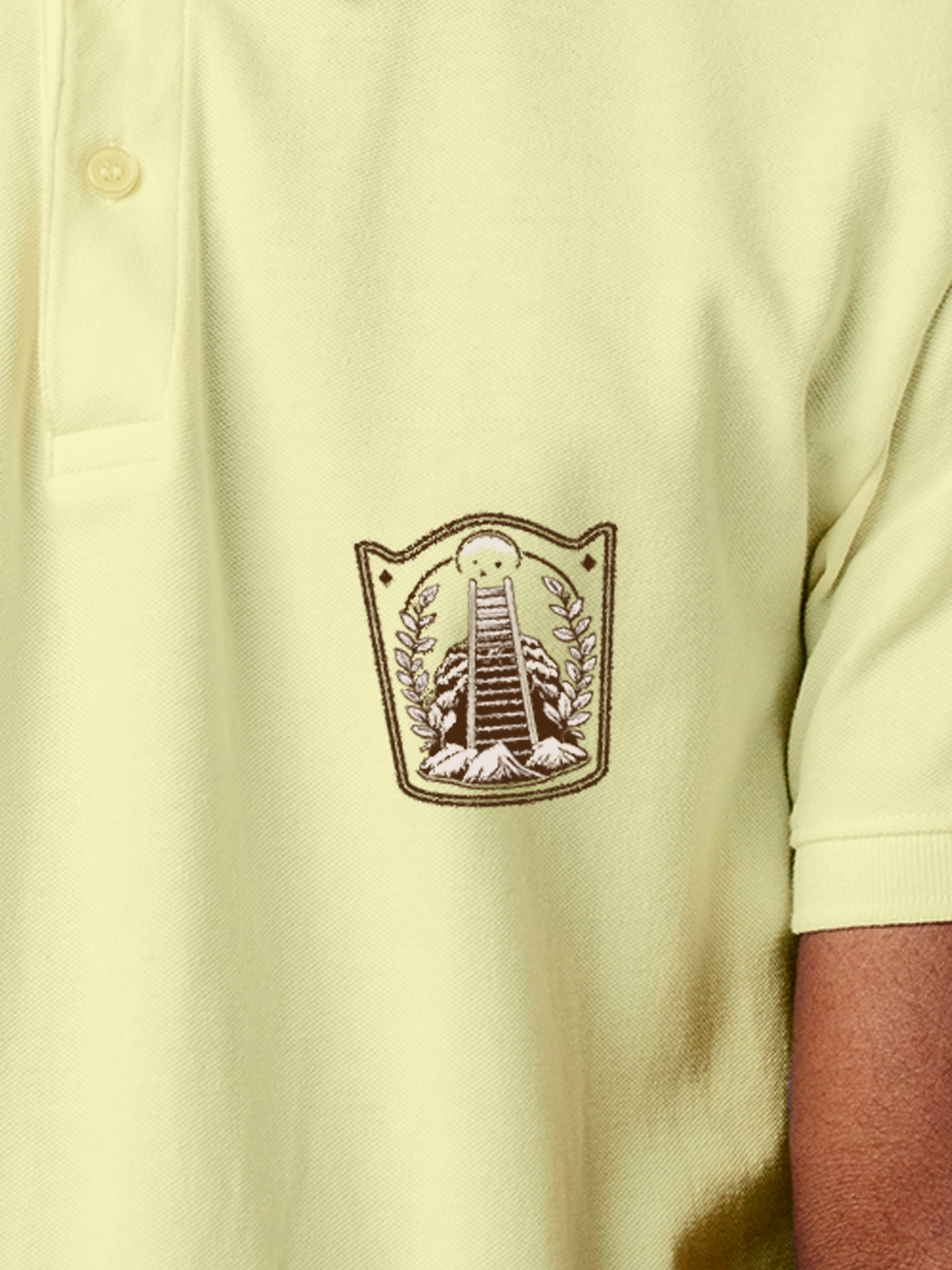 Close up of 'Ambition' design on Men's Yellow Polo T-shirt, highlighting intricate details and vibrant print.