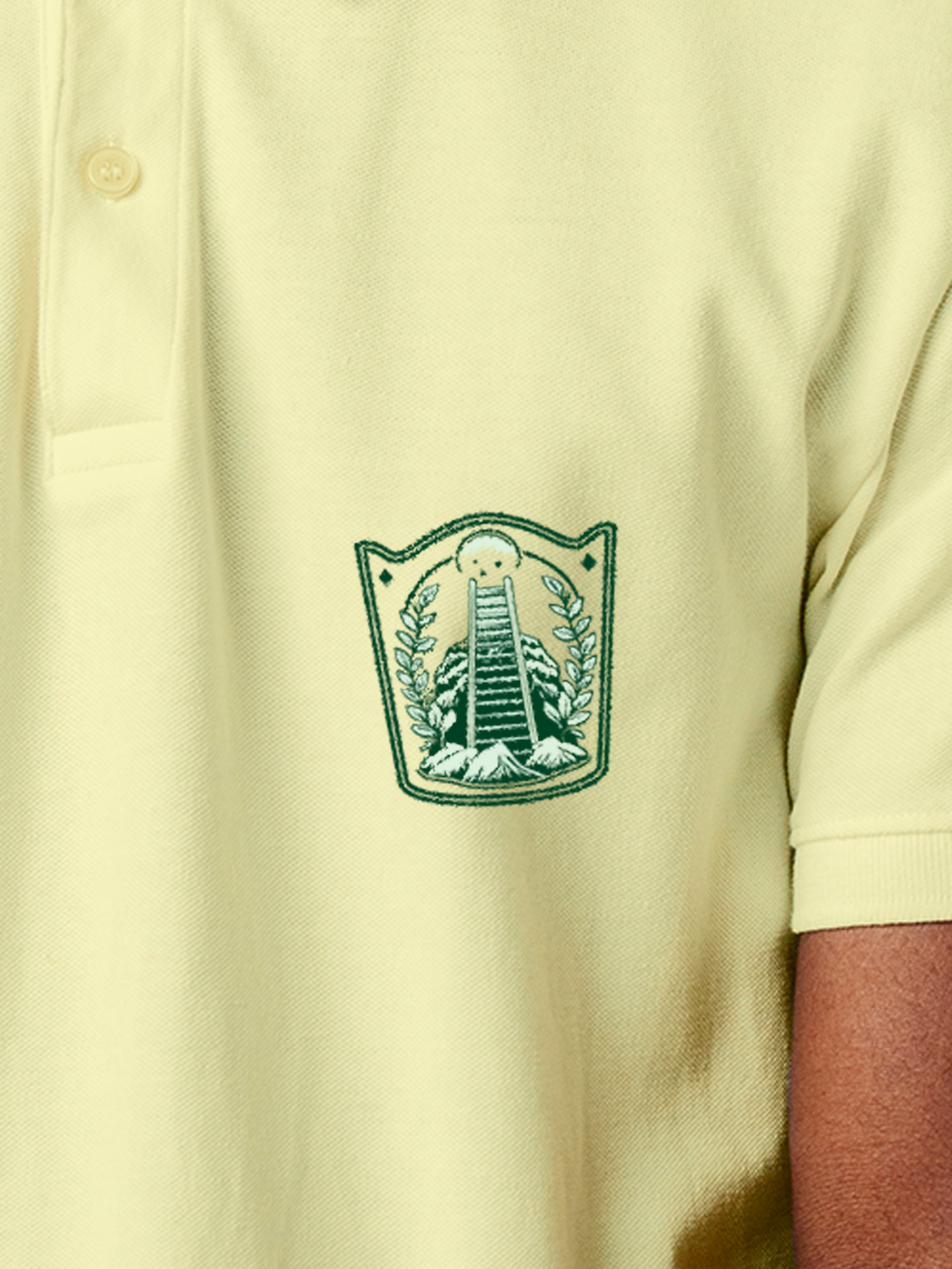 Close up of 'Ambition' design on Men's Yellow Polo T-shirt, highlighting intricate details and vibrant print.
