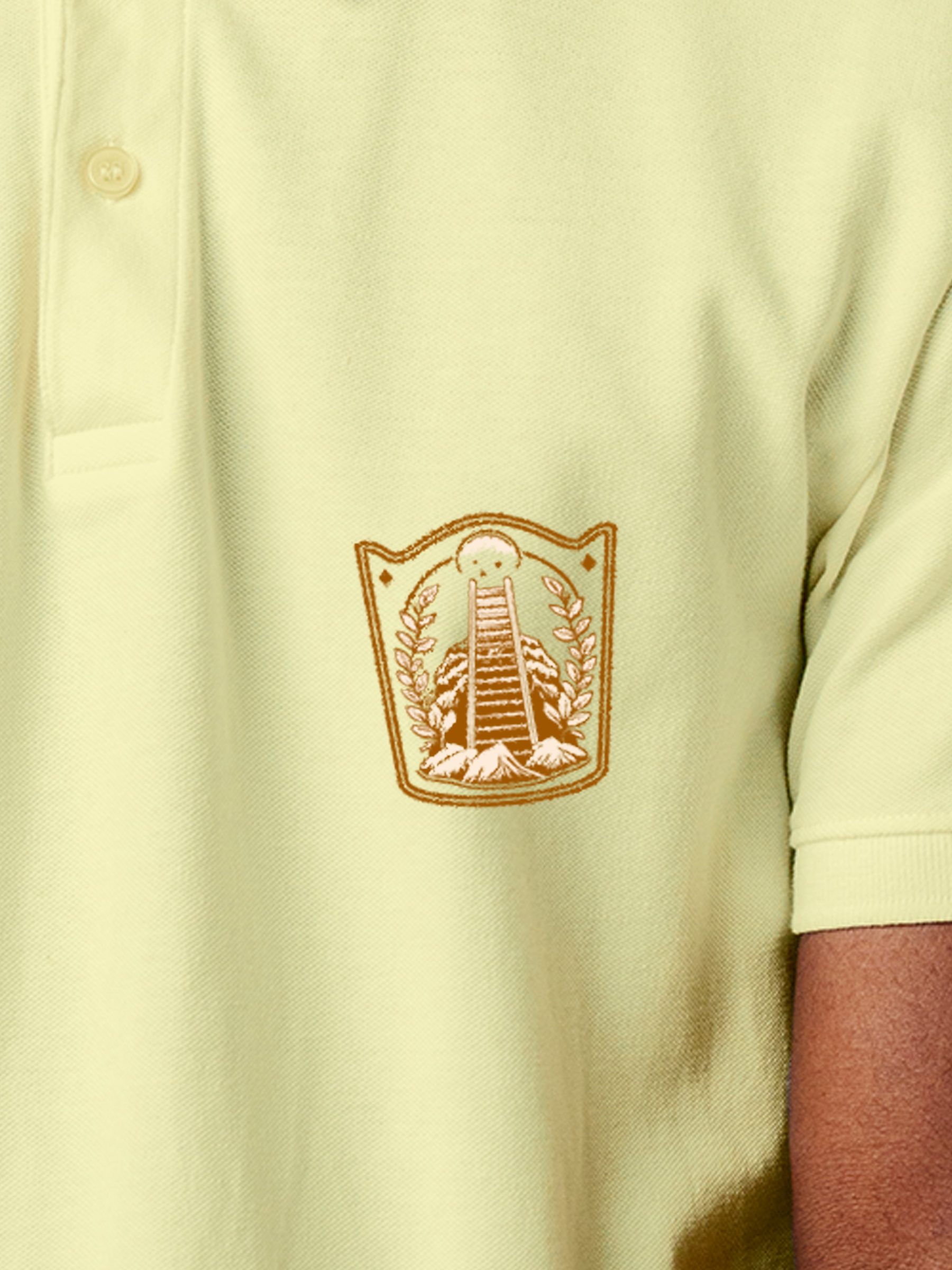 Close up of 'Ambition' design on Men's Yellow Polo T-shirt, highlighting intricate details and vibrant print.