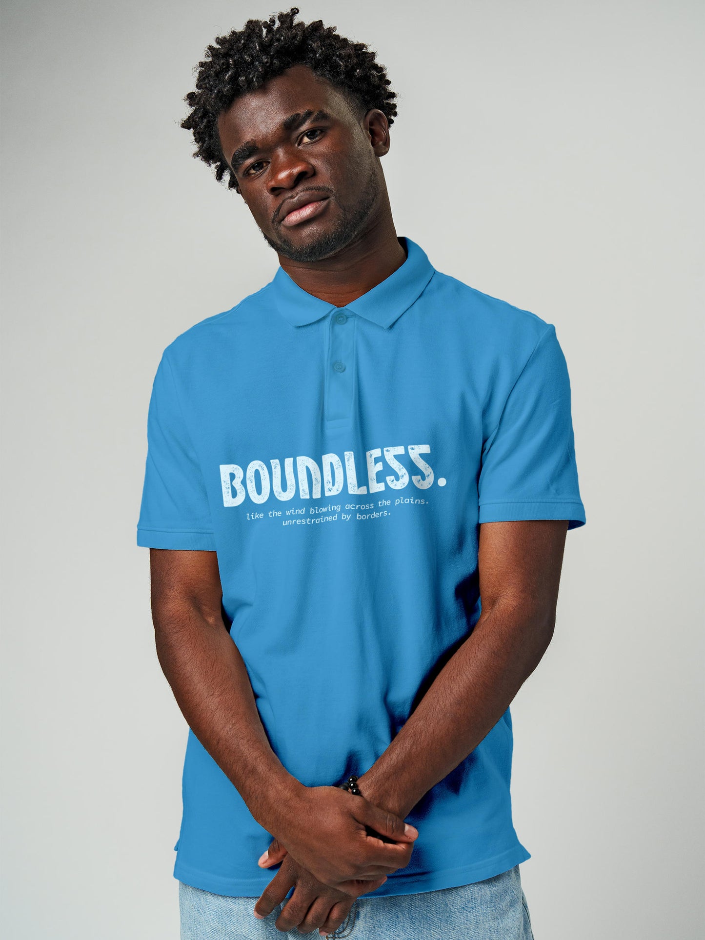 Model wearing Men's Blue Polo T-shirt with 'Free & Boundless' design, offering effortless style and premium comfort
