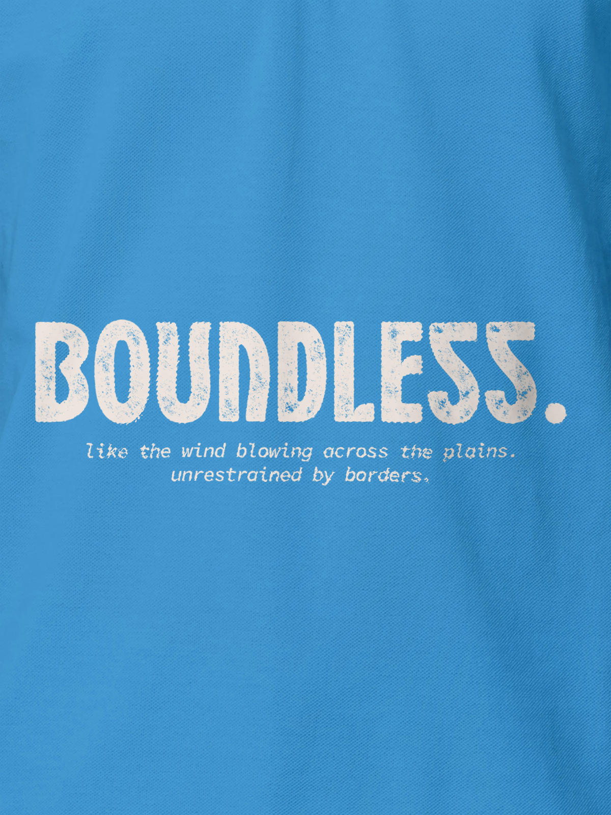 Close up of 'Free & Boundless' design on Men's Blue Polo T-shirt, highlighting intricate details and vibrant print.