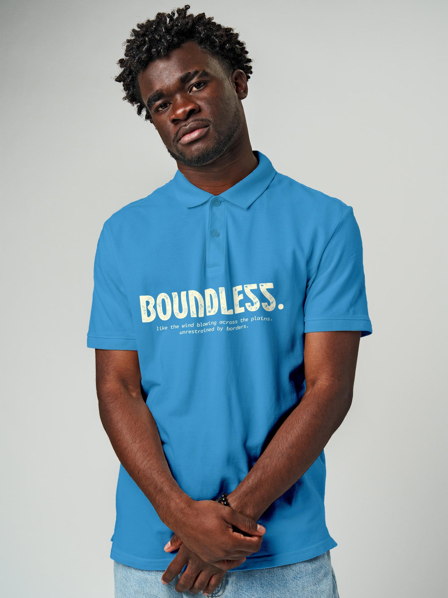 Model wearing Men's Blue Polo T-shirt with 'Free & Boundless' design, offering effortless style and premium comfort