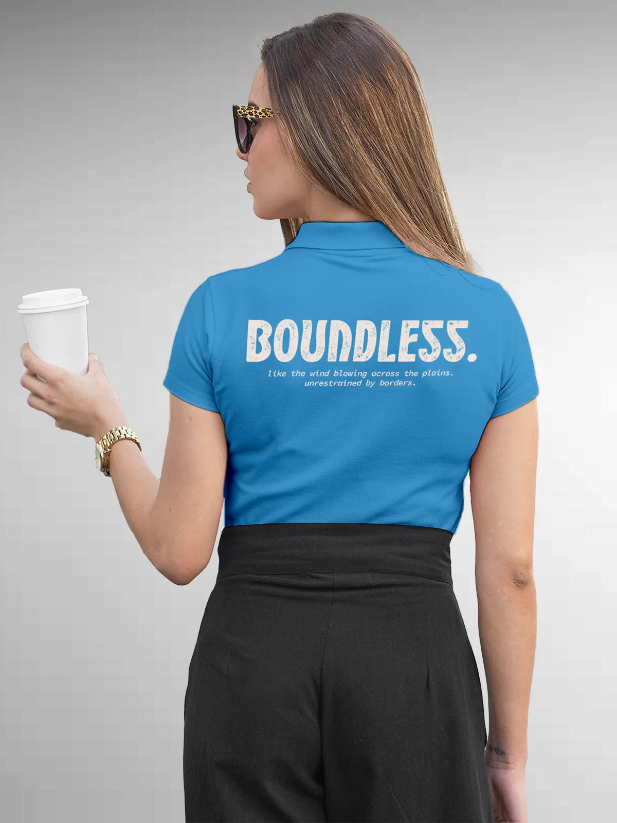 Model wearing Women's Blue Collar T-shirt with a big, bold 'Boundless' design printed on the back, along with an insiprational text