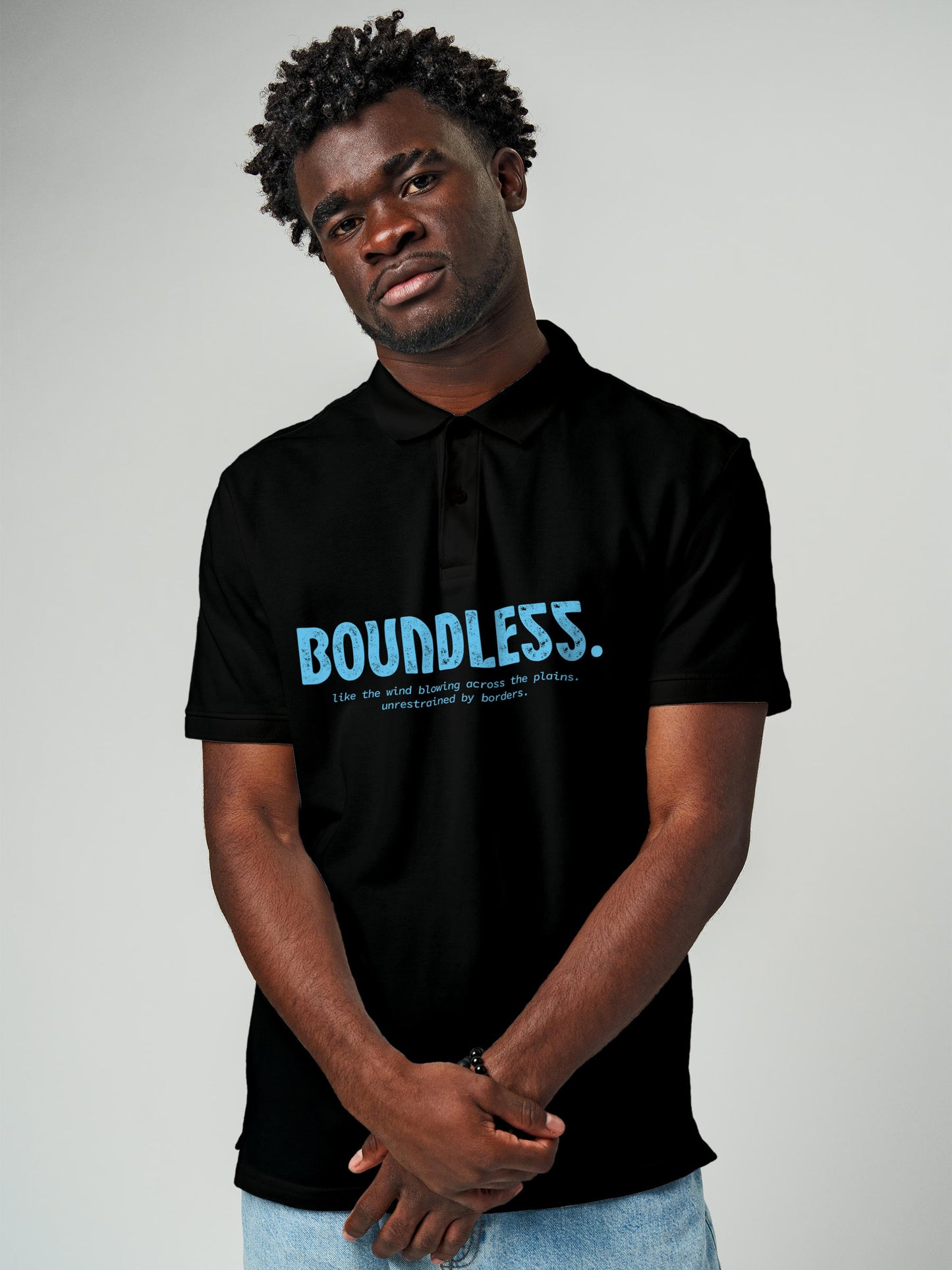 Model wearing Men's Black Polo T-shirt with 'Free & Boundless' design, offering effortless style and premium comfort