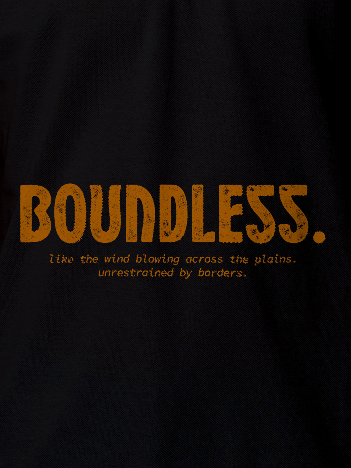 Close up of 'Free & Boundless' design on Men's Black Polo T-shirt, highlighting intricate details and vibrant print.