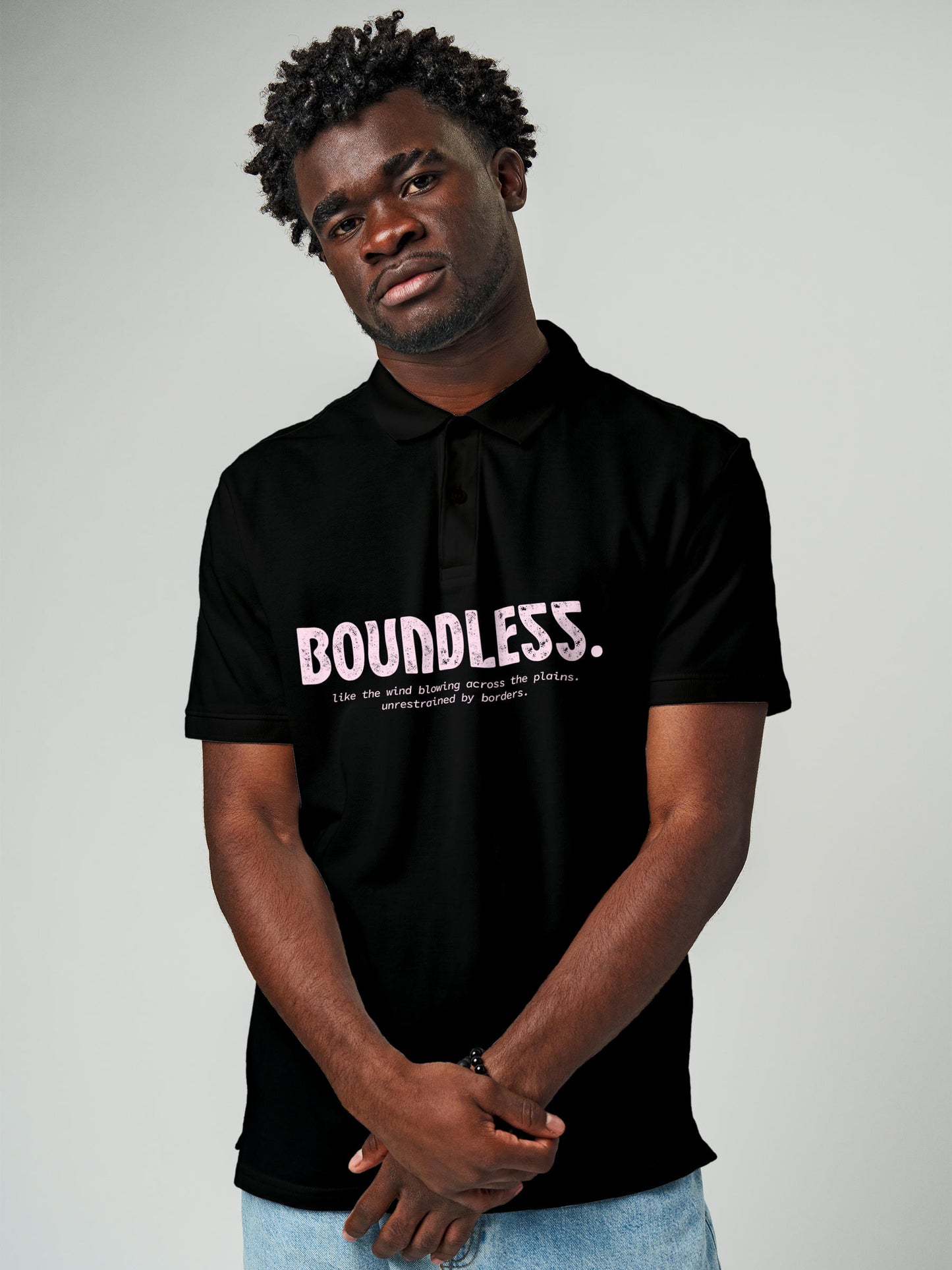 Model wearing Men's Black Polo T-shirt with 'Free & Boundless' design, offering effortless style and premium comfort