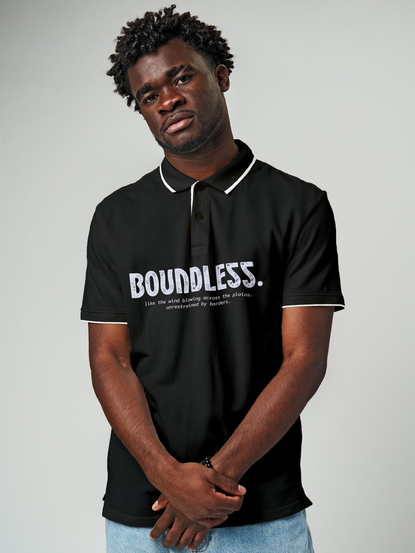 Model wearing Men's Dark Grey Polo T-shirt with 'Free & Boundless' design, offering effortless style and premium comfort