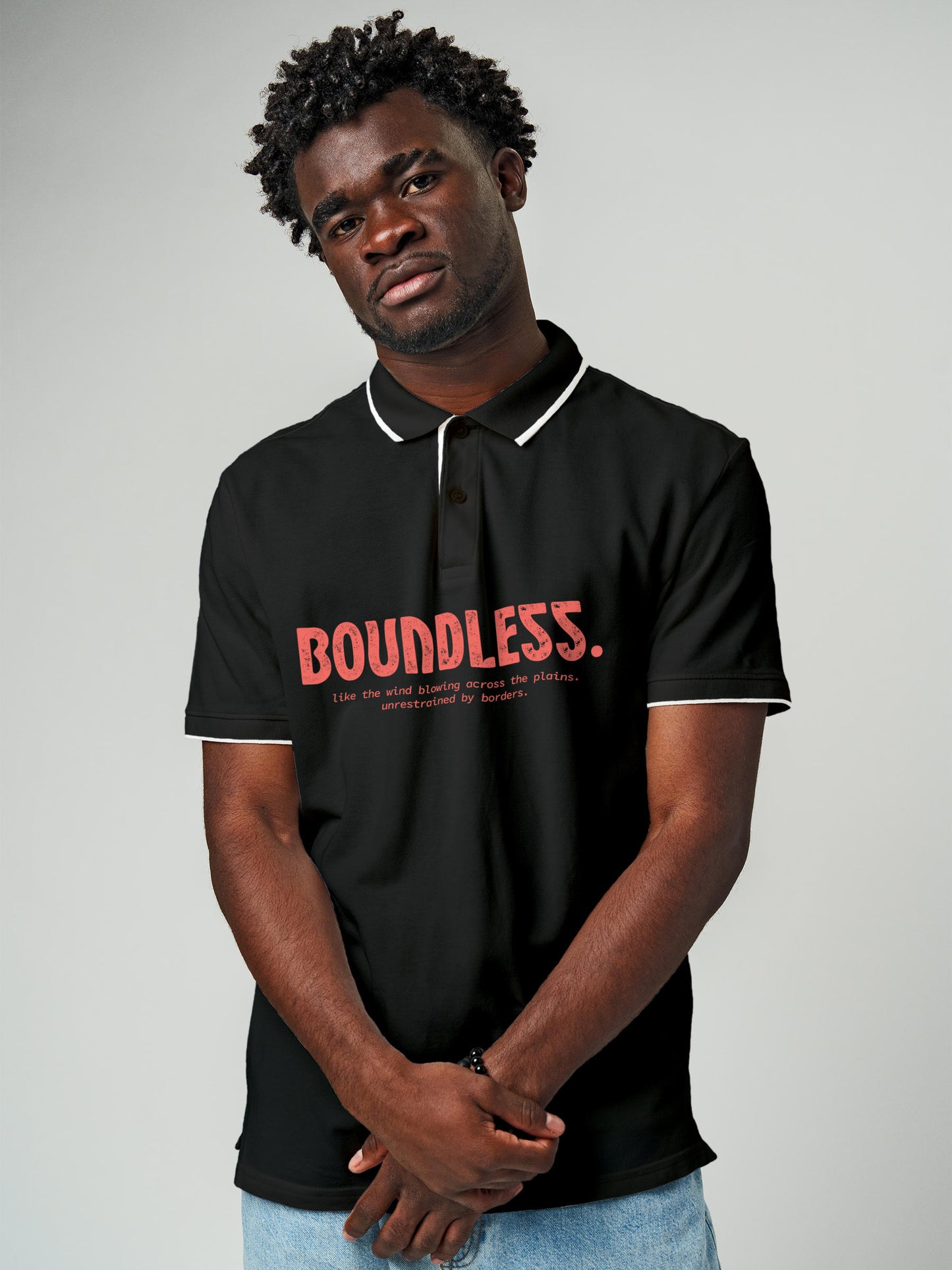 Model wearing Men's Dark Grey Polo T-shirt with 'Free & Boundless' design, offering effortless style and premium comfort